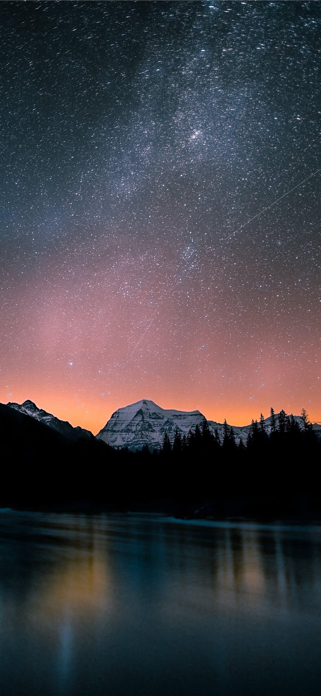 1125x2436 lake surrounded by trees and mountain under milky. iPhone X Wallpaper Free Download