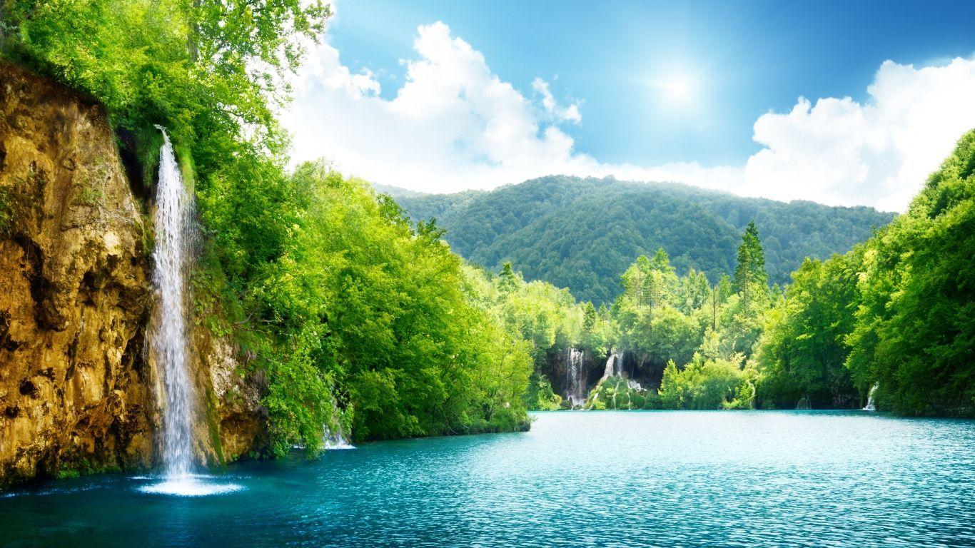 Download wallpaper 1366x768 sunny day forest mountains lake  reflections nature tablet laptop 1366x768 hd background 17977