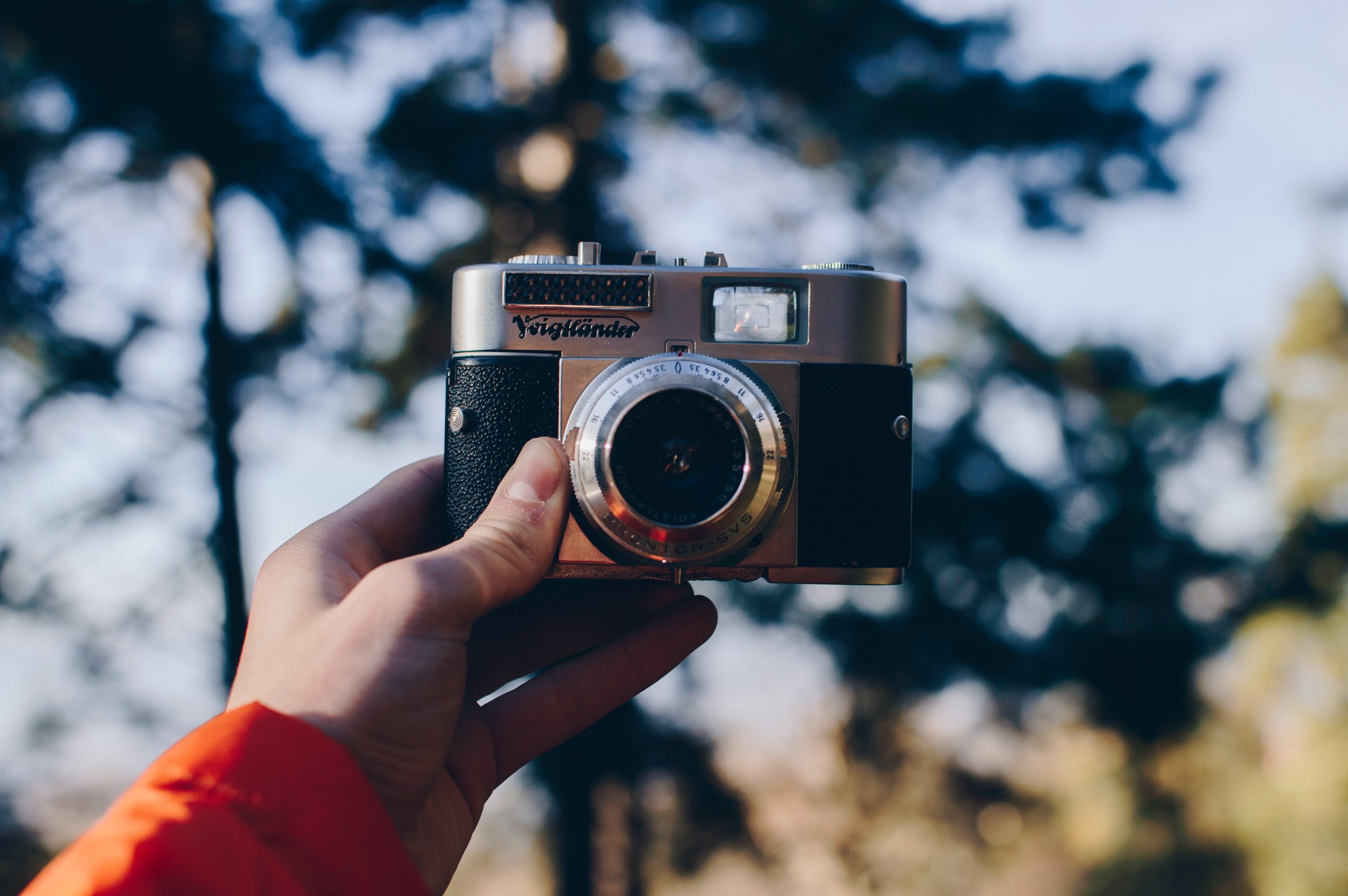 3840x2553 Wallpaper / a person holding a 35mm camera in their hand, 35mm camera 4k wallpaper free download