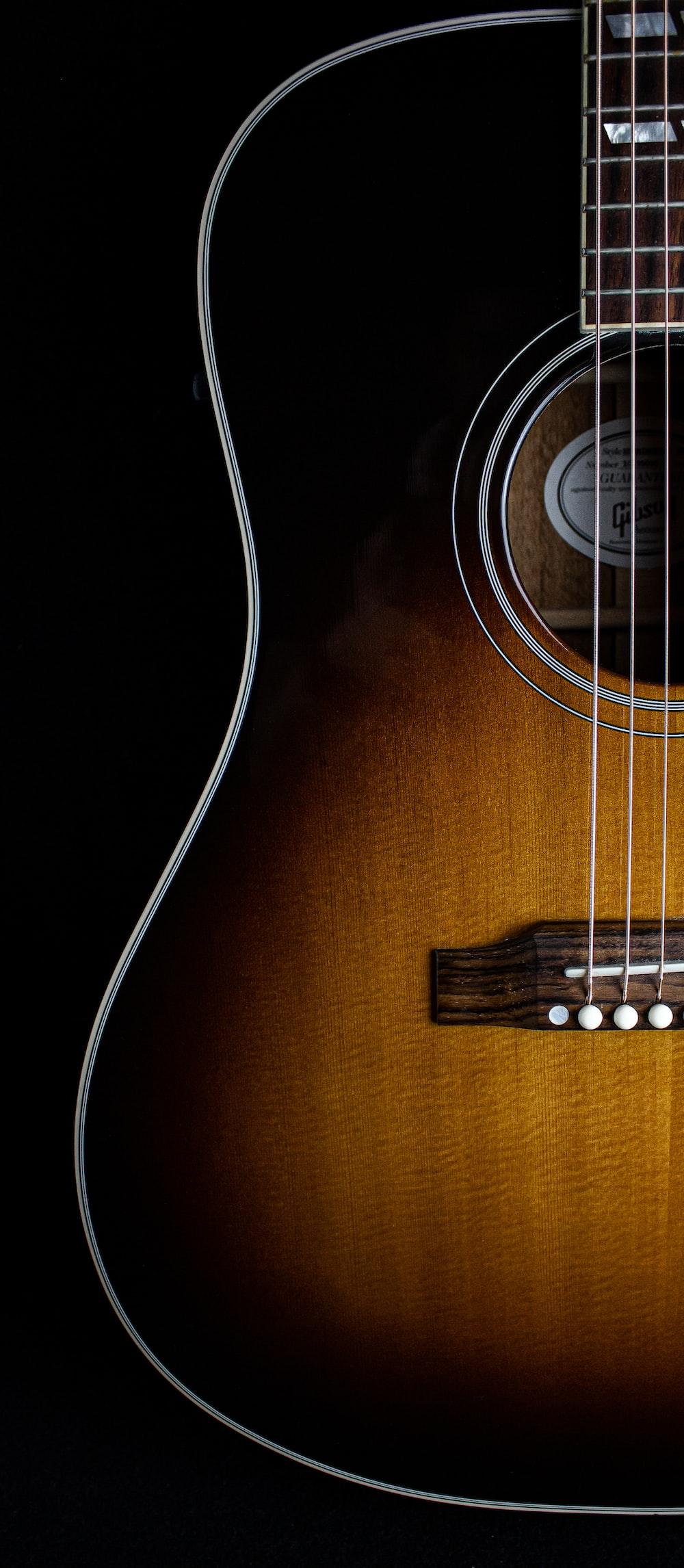 1000x2292 brown acoustic guitar on black background photo