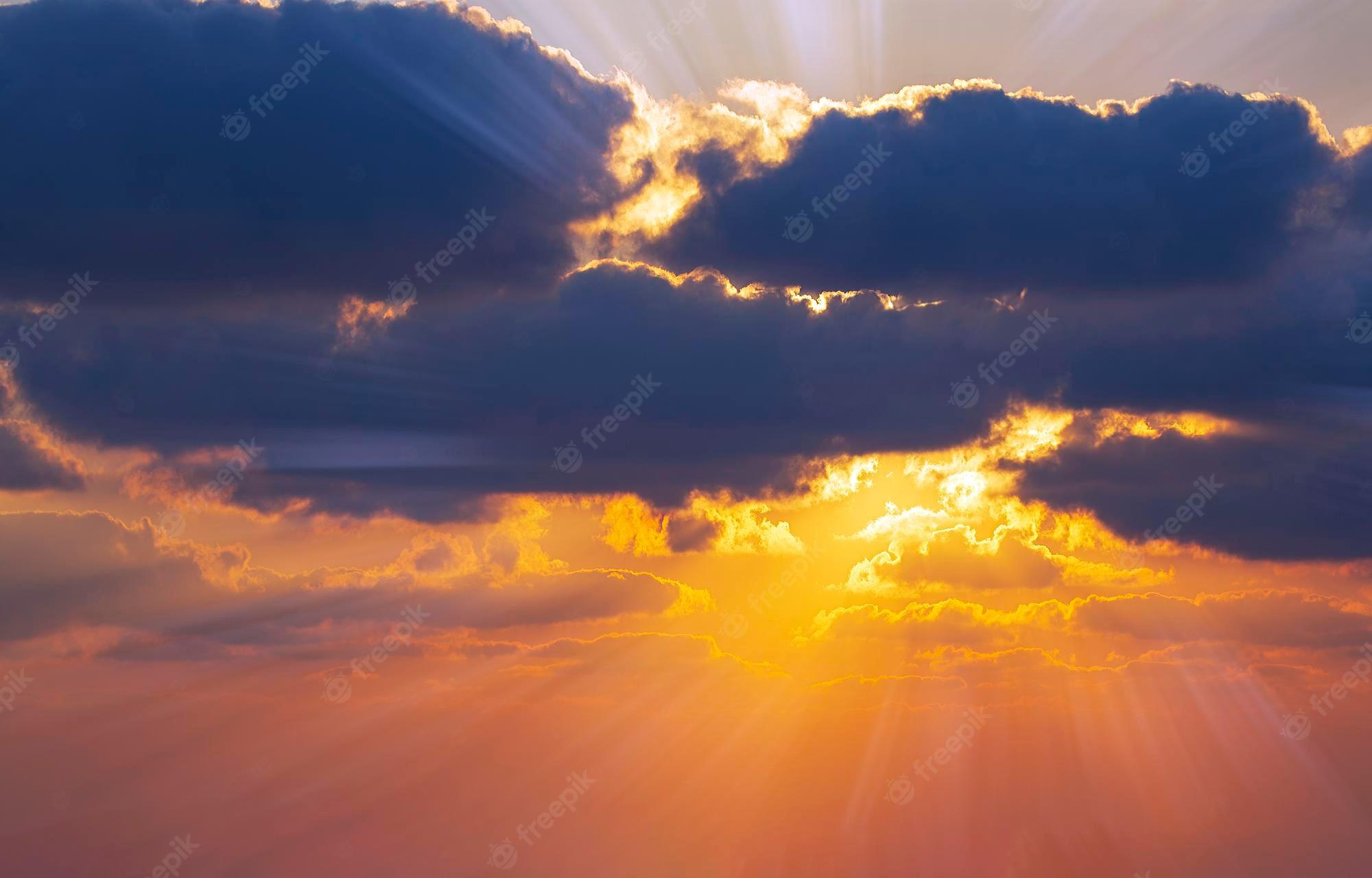 2000x1280 Premium Photo. Dramatic yellow sunset sky wallpaper beautiful dark blue sky evening beauty and cloud at sunset dawn the rays of the sun breakuds dusk colorful horizon background