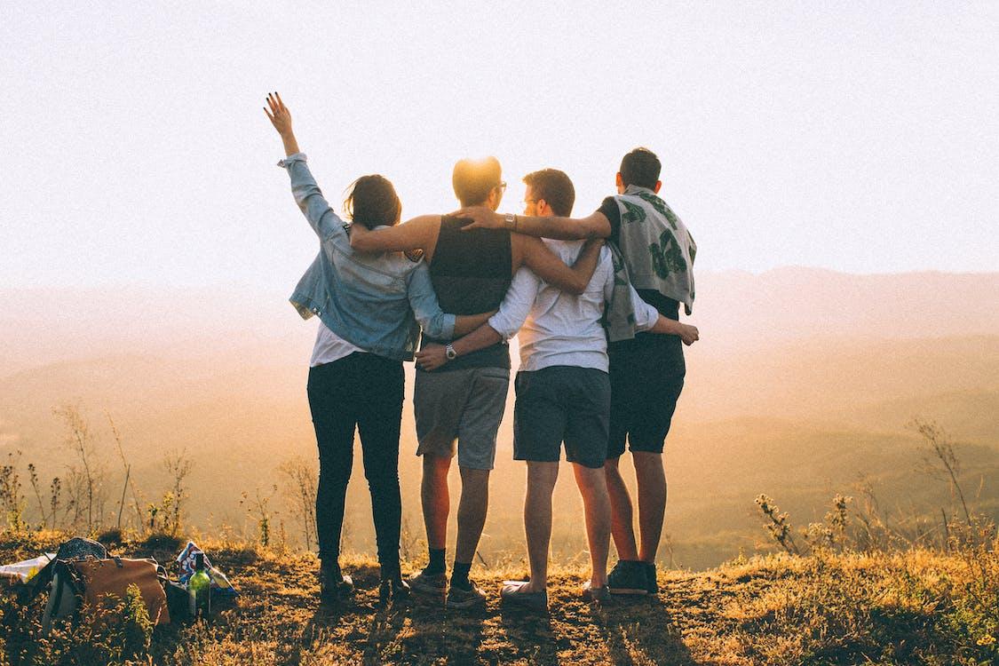 1125x750 Anonymous friends standing together at sunset in mountains · Free