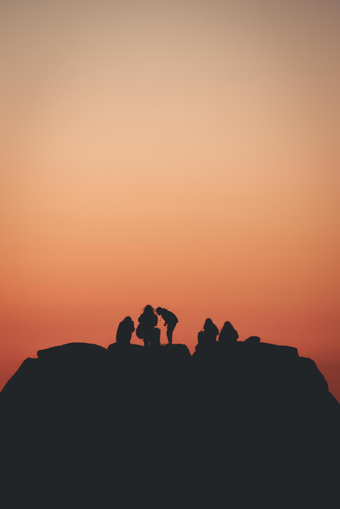1307x1960 Silhouette of a group of friends over a colorful sunset