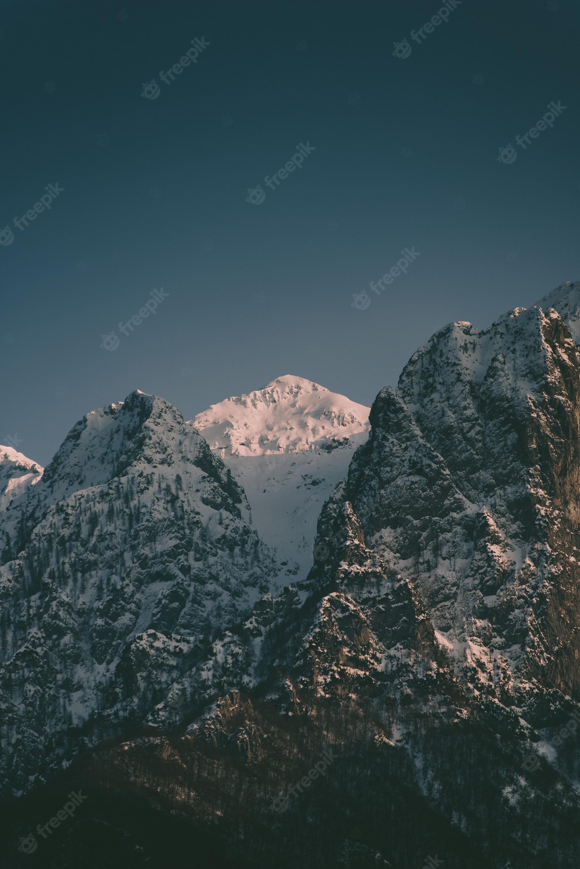 2000x2996 Free Photo. Beautiful high rocky mountains with a snowy mountain in between