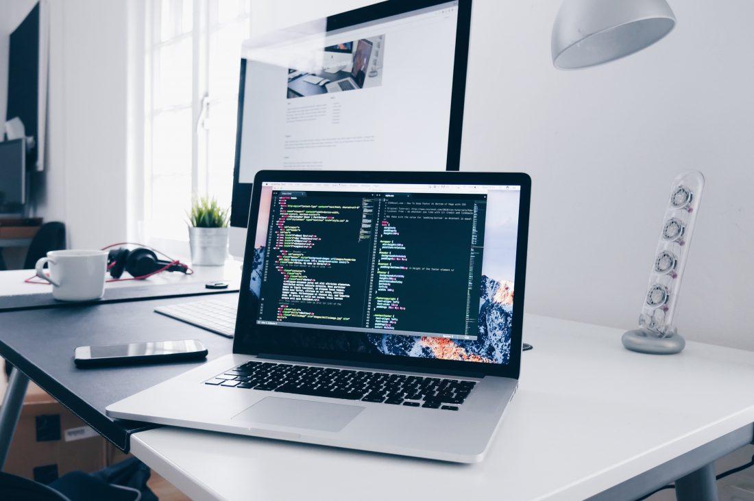 1100x732 Code On A MacBook Laptop In Minimal Office Royalty Free And Image
