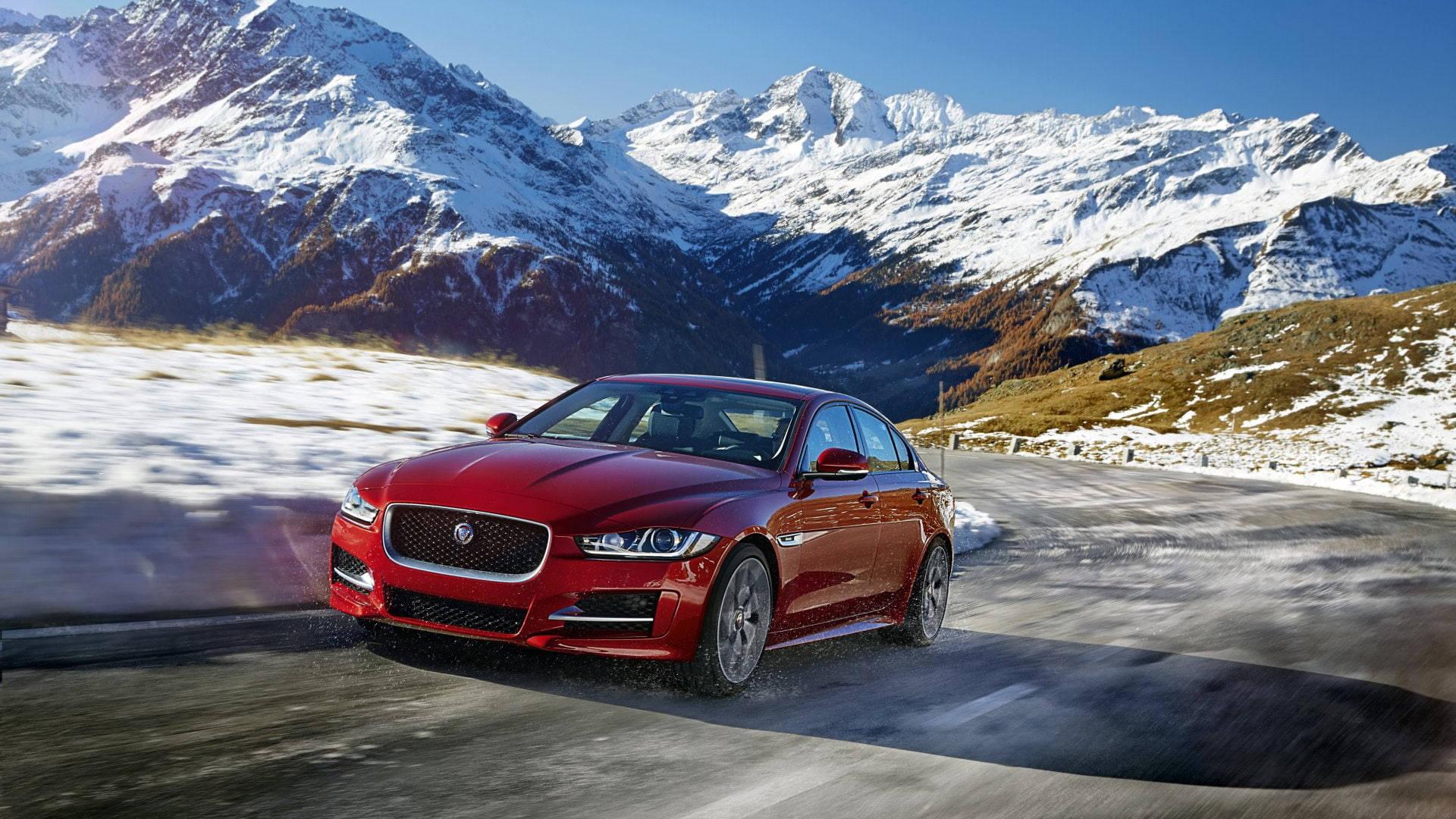 1920x1080 Download Red Jaguar Car Passing Mountains Wallpaper