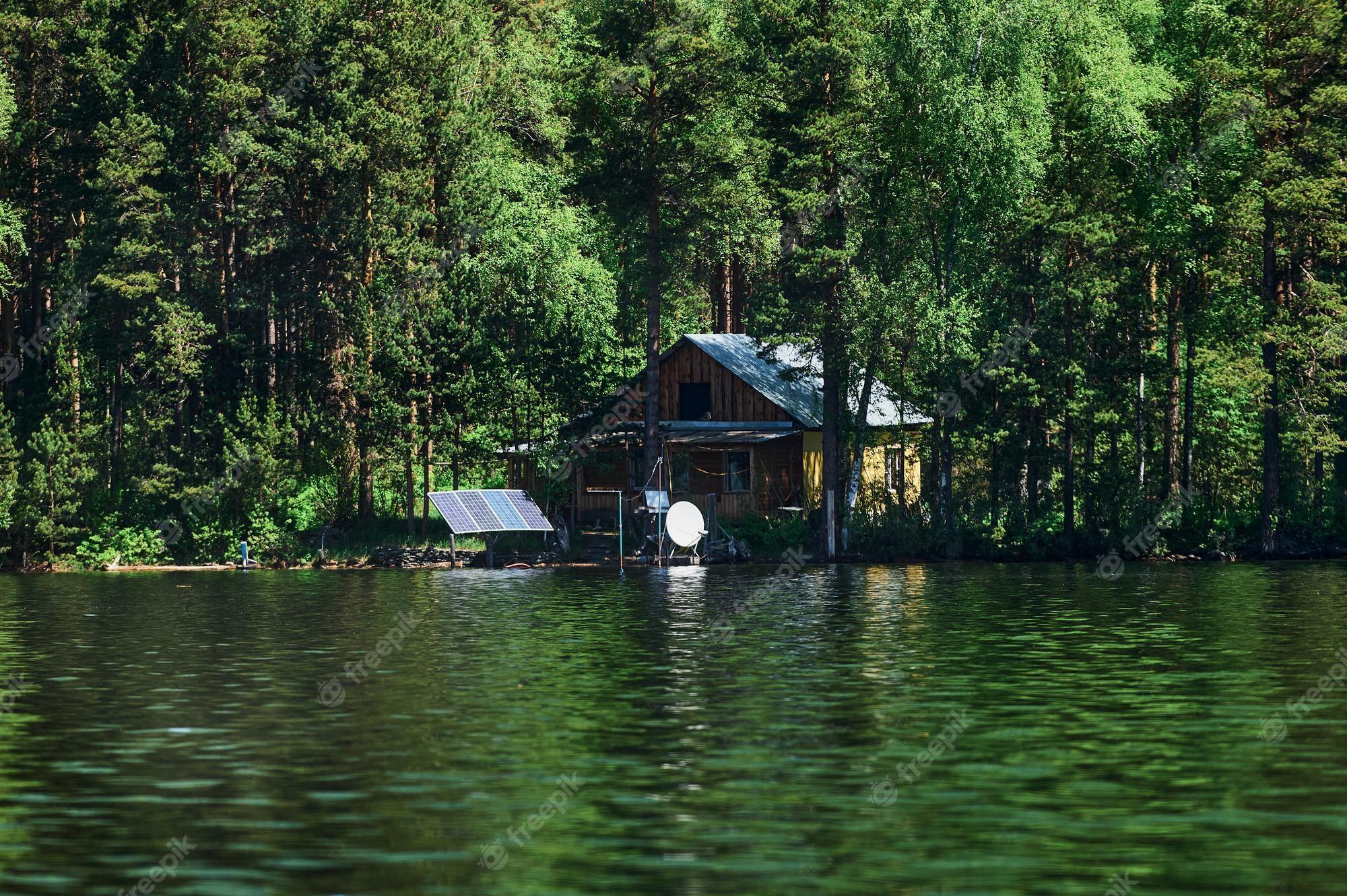 2000x1331 Premium Photo. Breathtaking and colourful scenery of a fairy tale view with a rocky house next to the lake and a small boat in front of it in a beautiful natural