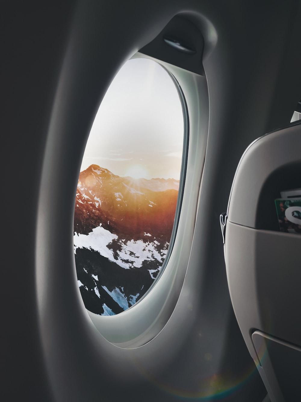 1000x1333 plane window showing mountain photo