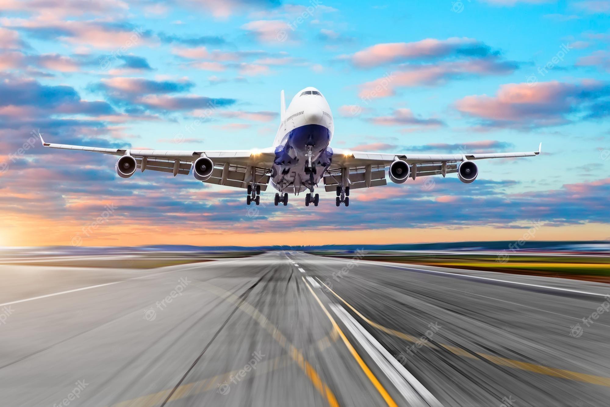 2000x1333 Premium Photo. Wing view runway at the airport sky and a airplane taking off in the distance