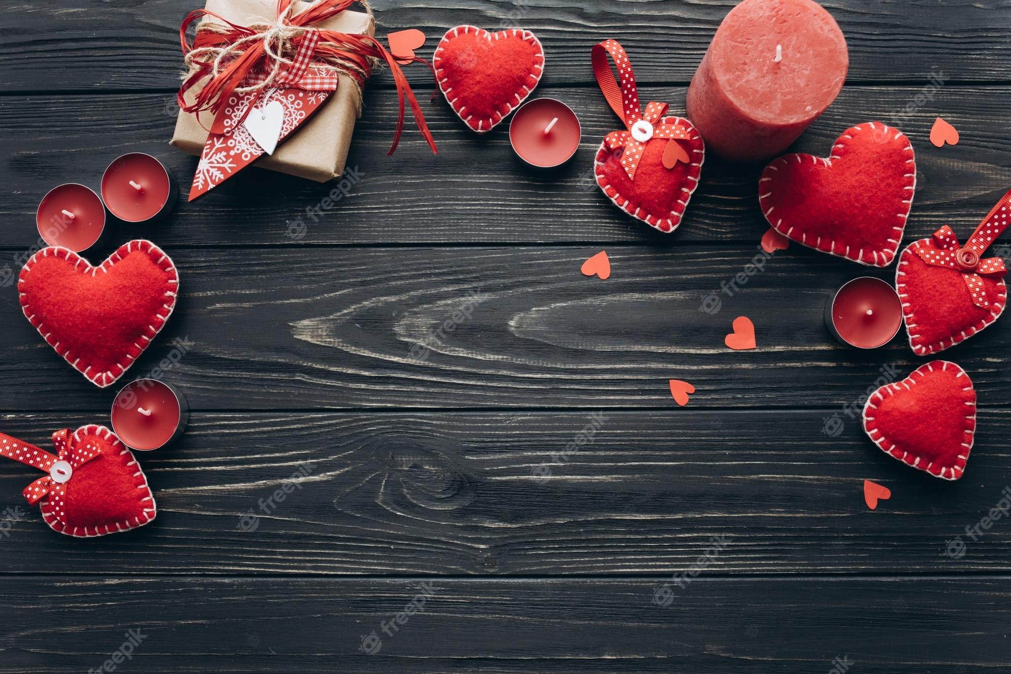 2000x1333 Premium Photo. Banner for valentine day with decorative hearts, candles and gifts on a dark wooden background