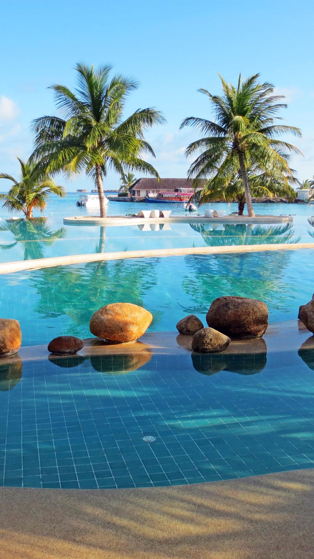 1080x1920 Holiday Inn Maldives Resort Pool Palm Trees Download Free Wallpaper for iPhone 6s, 7s, 8s, 10