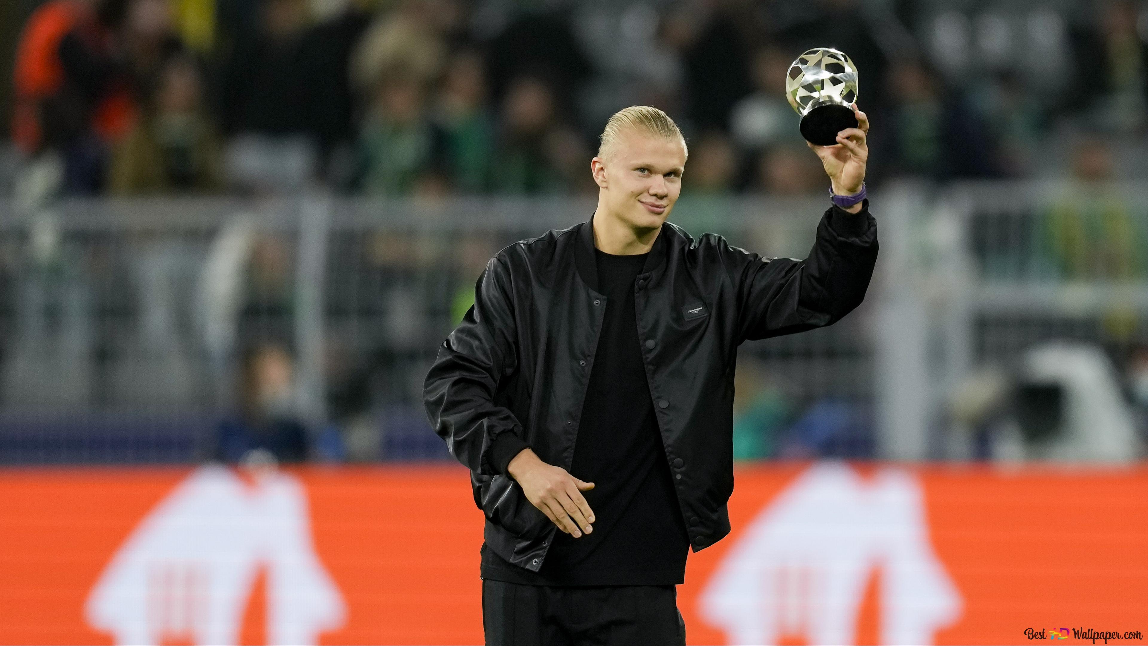3840x2160 Manchester City young forward Erling Haaland poses at the stadium holding the trophy 4K wallpaper download
