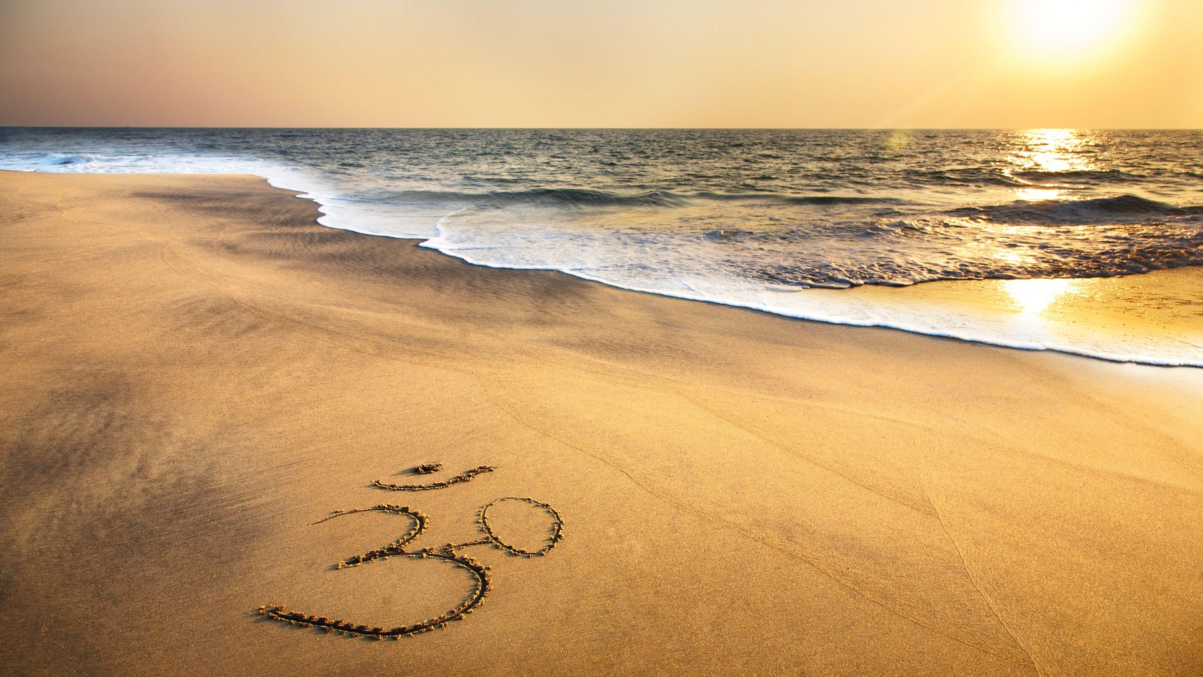3840x2160 Om Symbol At Beach Sand Ocean Wallpaper