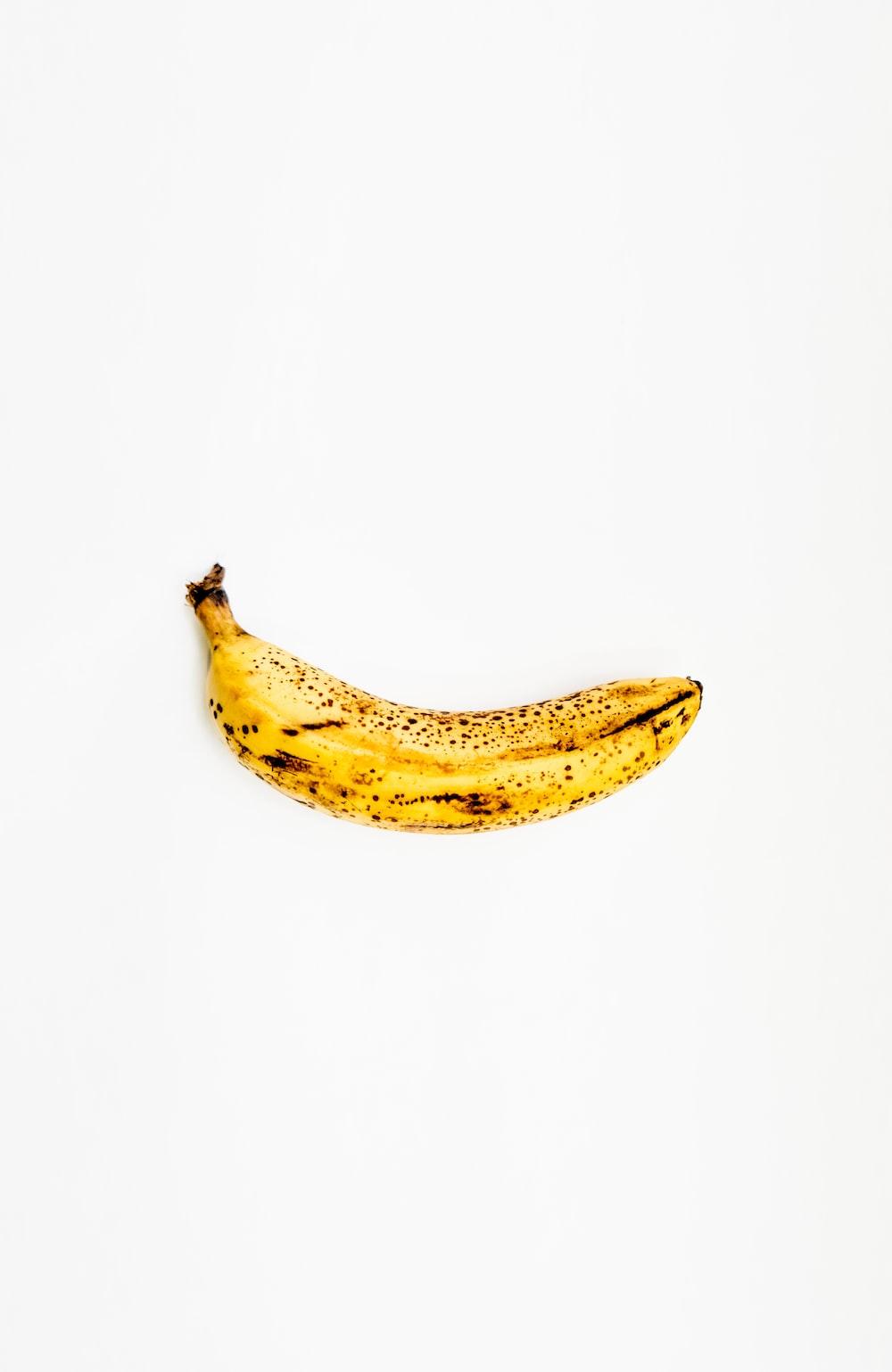 1000x1539 yellow banana on white surface photo