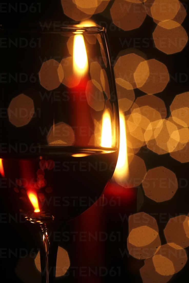 737x1106 Germany, Glass of red wine with Christmas lights in background