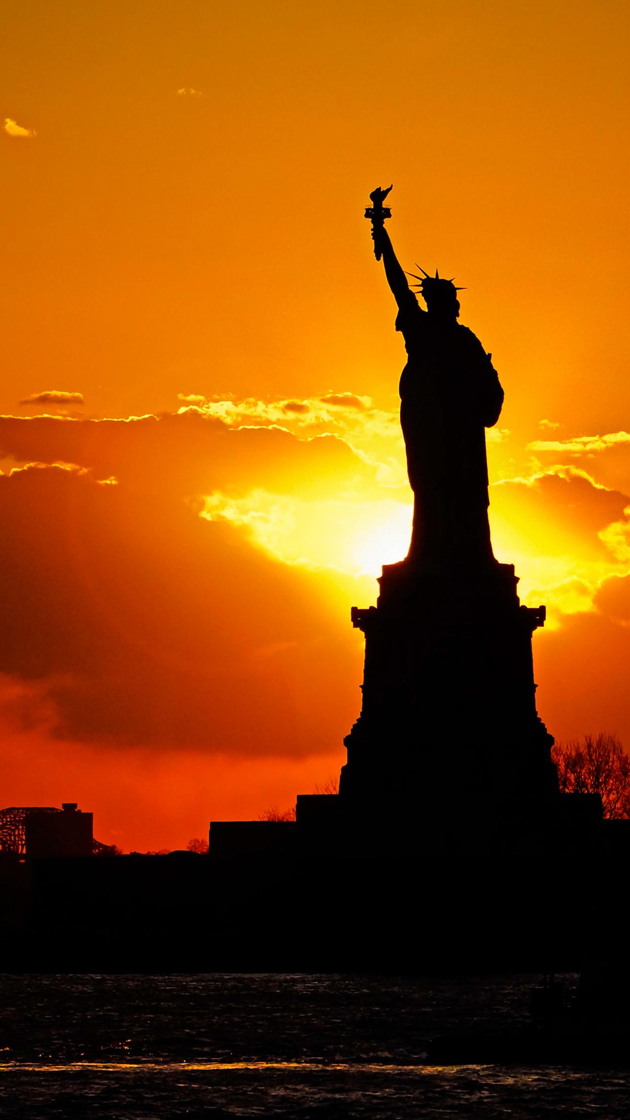 1242x2208 Sunset behind Statue of Liberty Wallpaper for iPhone Pro Max, X, 6