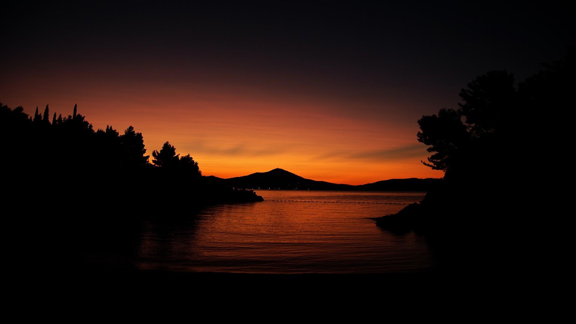 1920x1080 sunset, Nature, Silhouette, Trees, Water, Calm, Dark, Orange, Hill Wallpaper HD / Desktop and Mobile Background