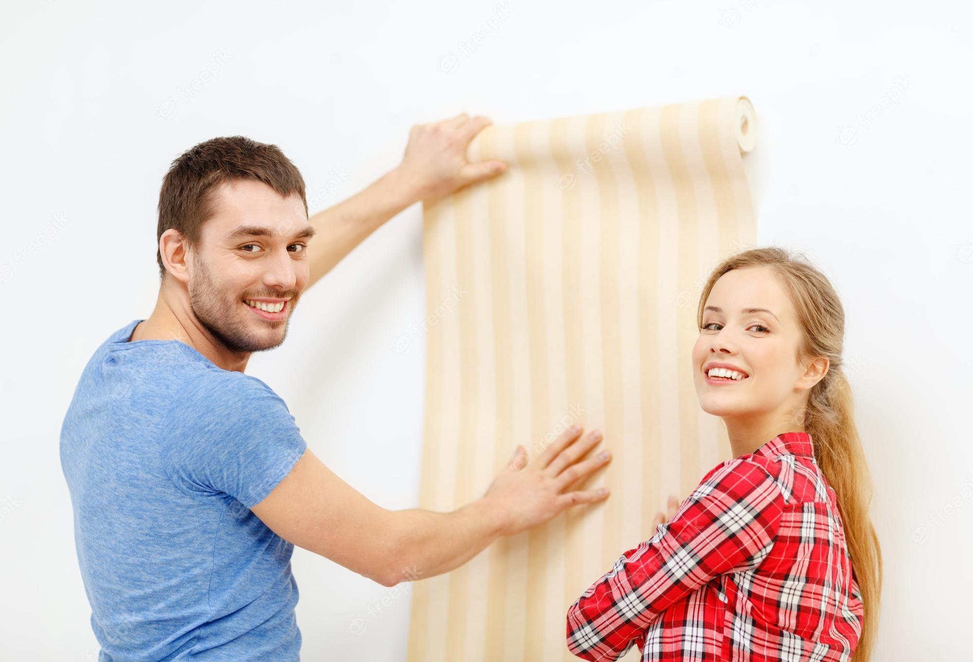 2000x1361 Premium Photo. Repair, interior design, building, renovation and home concept couple choosing wallpaper for new home