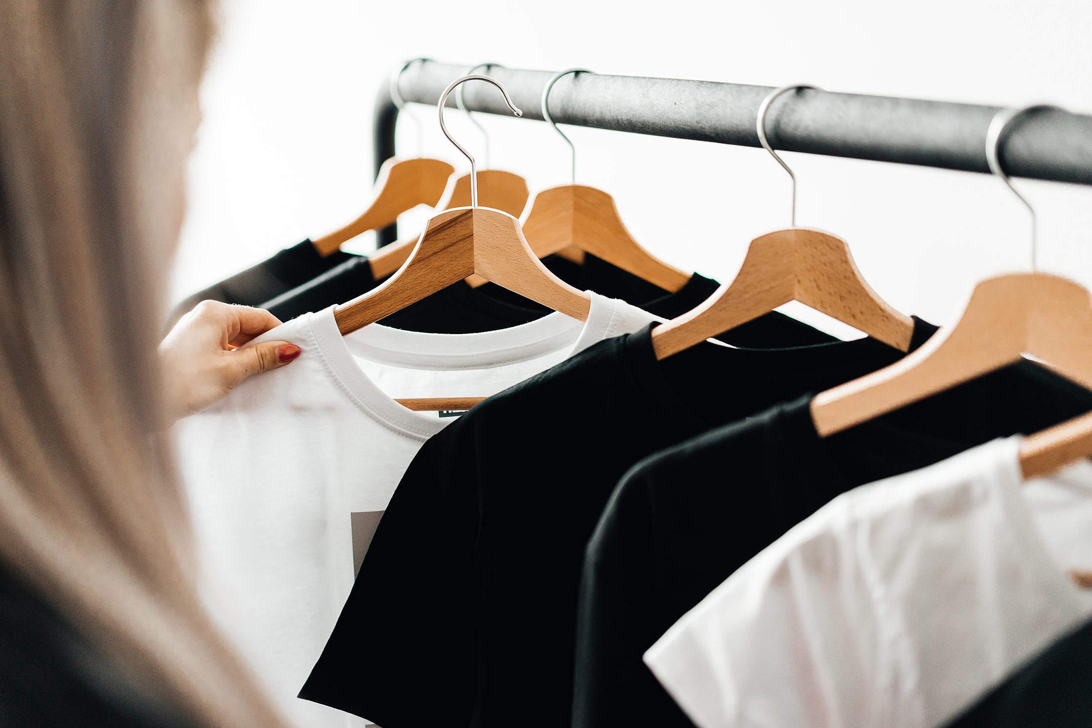 2210x1473 Woman Choosing T Shirts During Clothing Shopping At Apparel Store Free