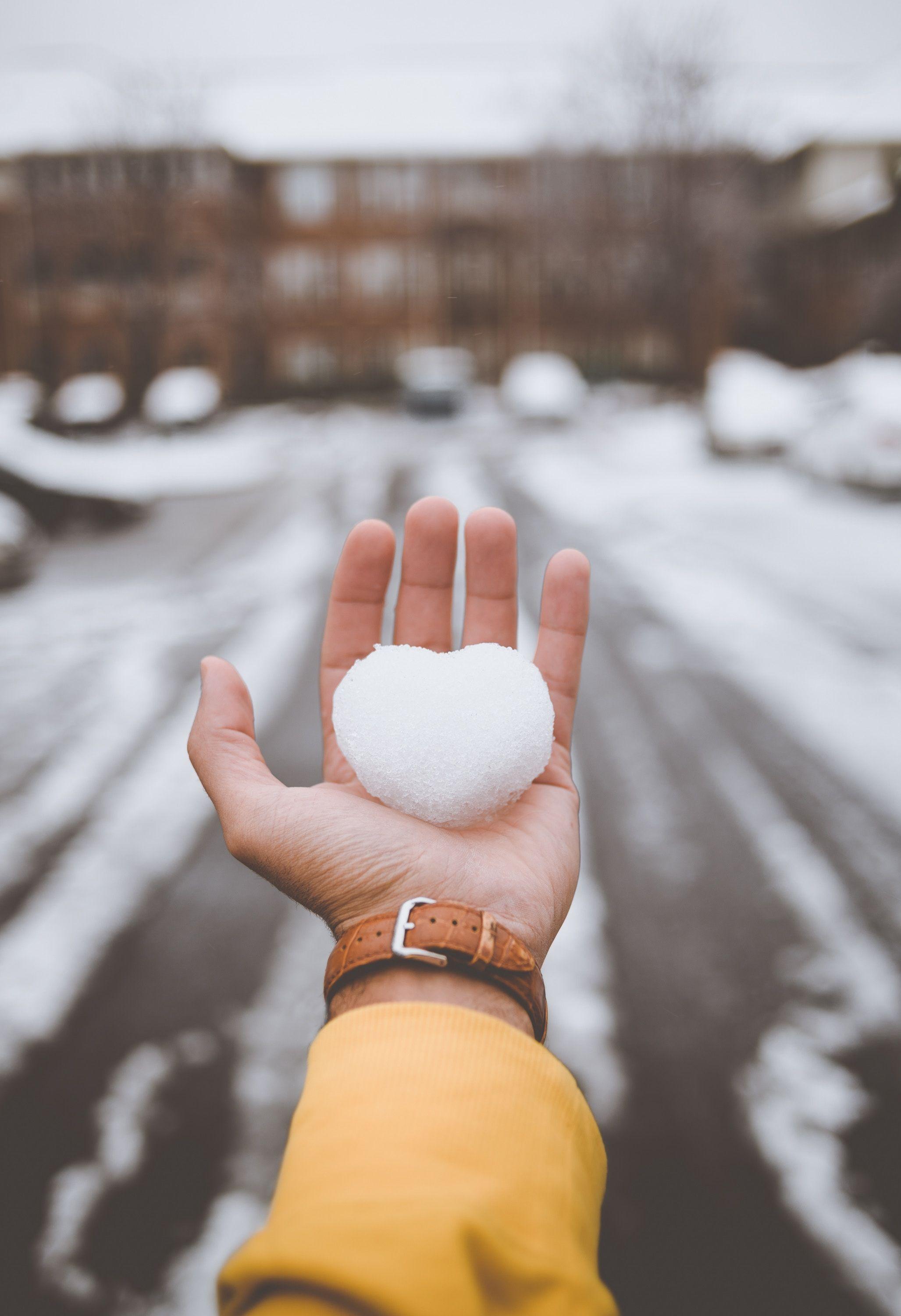 2055x3000 Download wallpaper 2055x3000 hand, snow, heart, winter, love HD