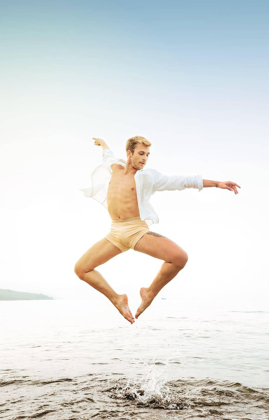 910x1423 Download Dance Pose Male Ballet Dancer Beach Wallpaper