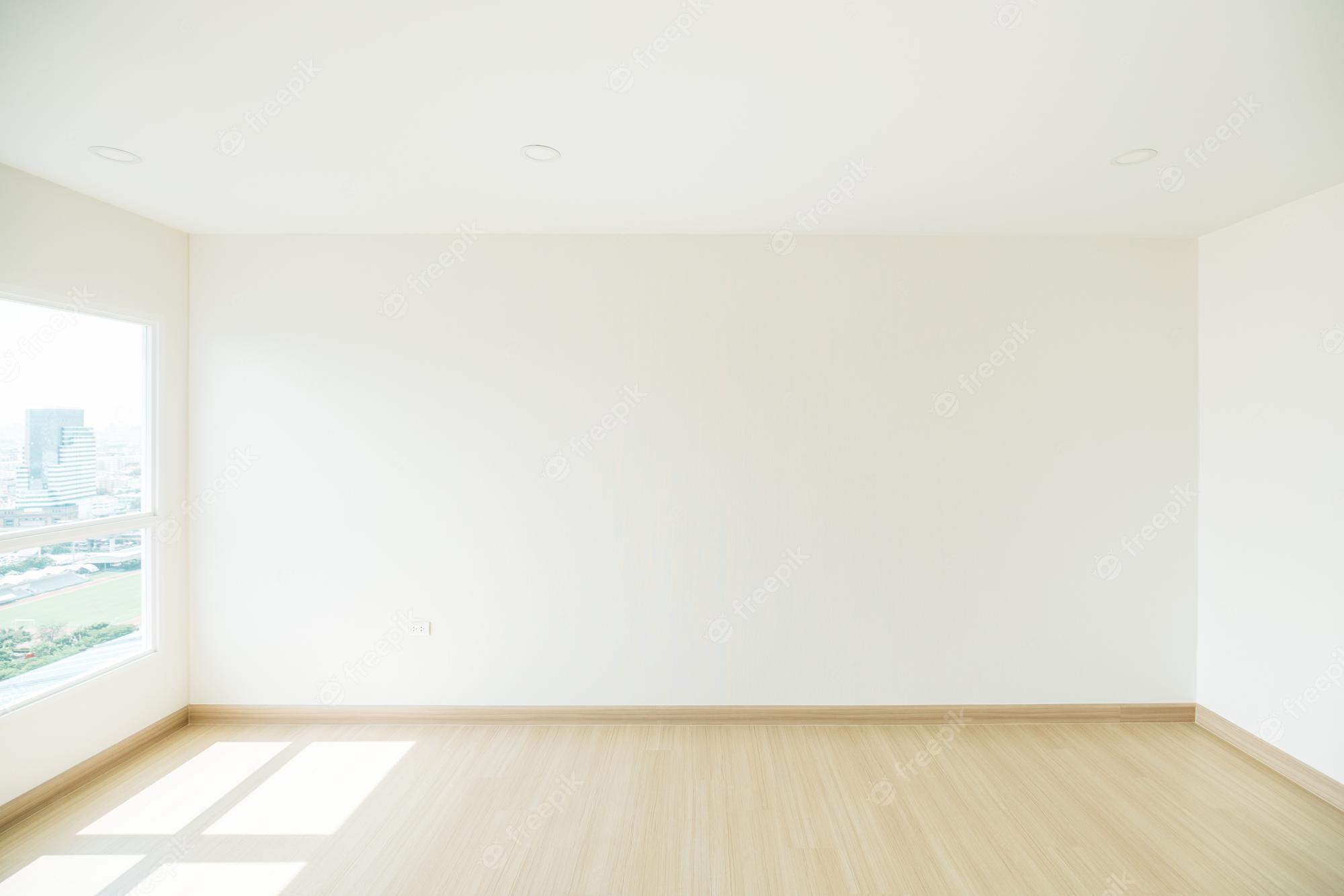2000x1334 Premium Photo. Empty room is decorated with an engineering wooden floor and wallpaper on the wall with sunlight from the window minimalist interior design and real estate for decoration real image