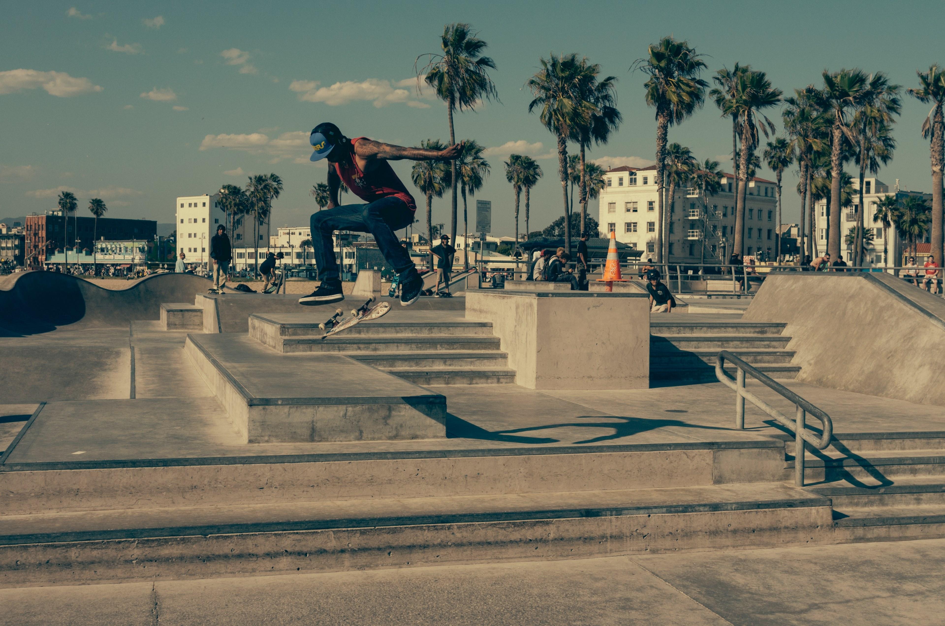3840x2543 Wallpaper / a man doing a trick on a skateboard at a skatepark by the beach, skate tricks 4k wallpaper free download