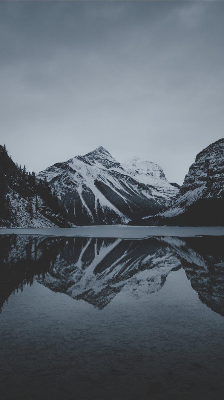 750x1334 snow mountains and lake undr gray sky iPhone 8 Wallpaper Free Download