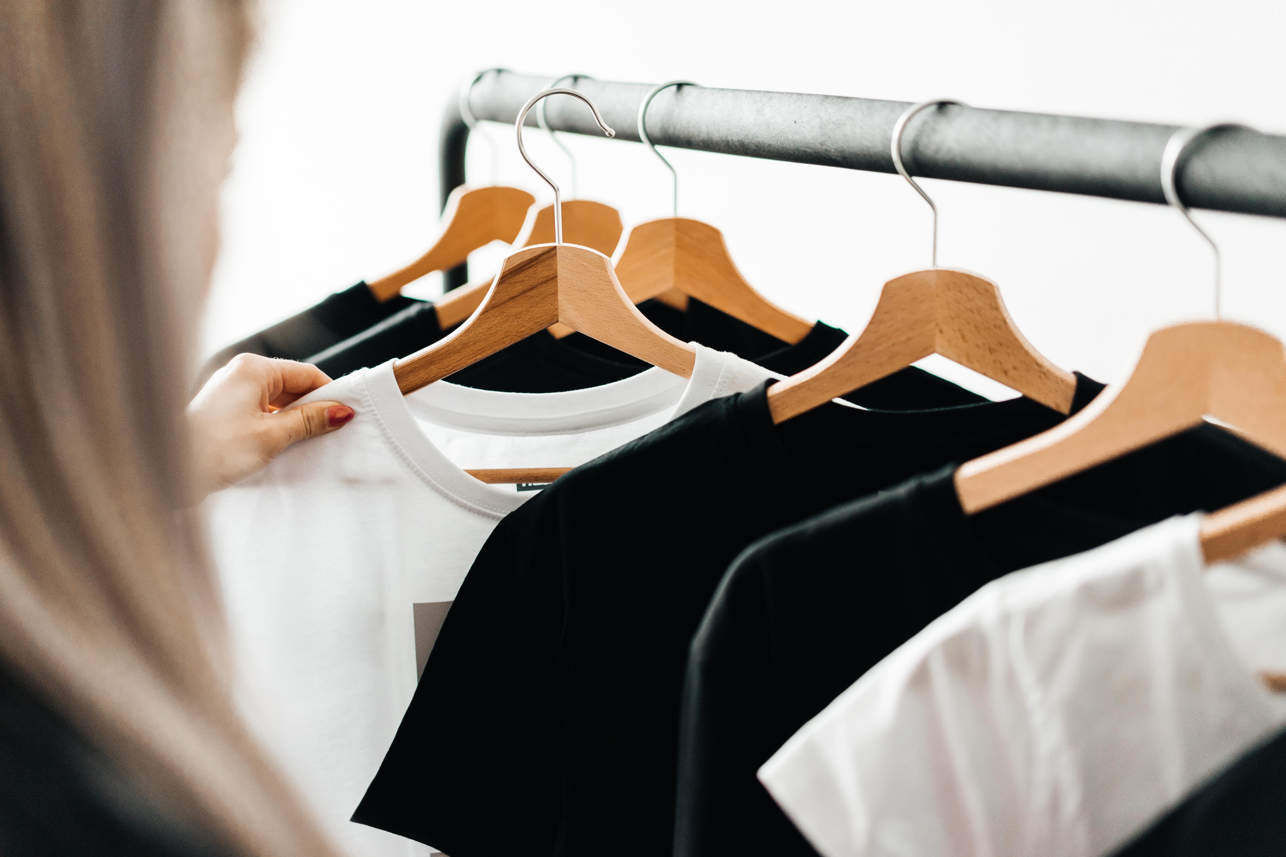 5000x3333 Woman Choosing T Shirts During Clothing Shopping At Apparel Store Free