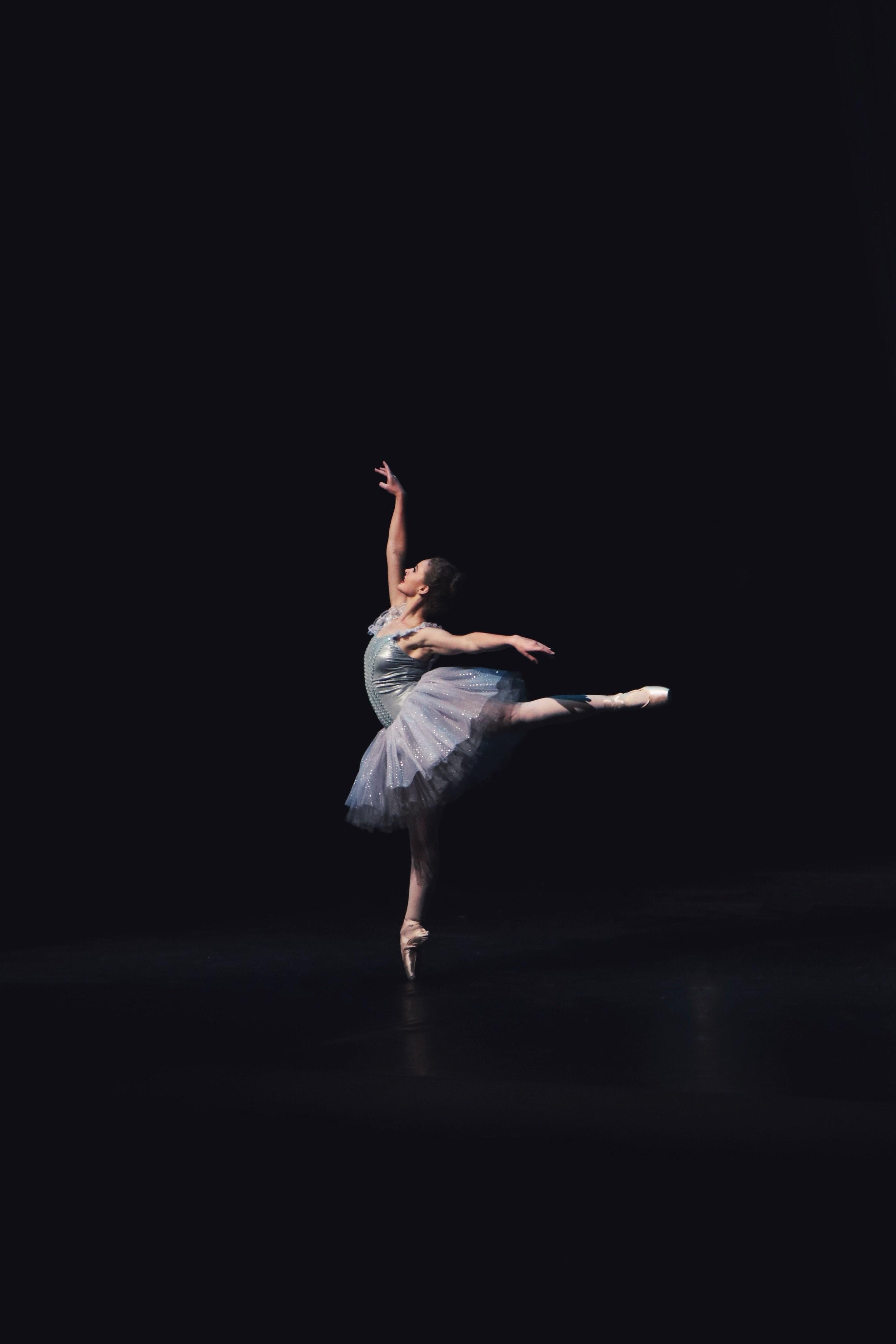 2731x4096 Wallpaper / ballet dancer performing in rehearsal executing graceful pose in dark room, ballerina dancing 4k wallpaper free download