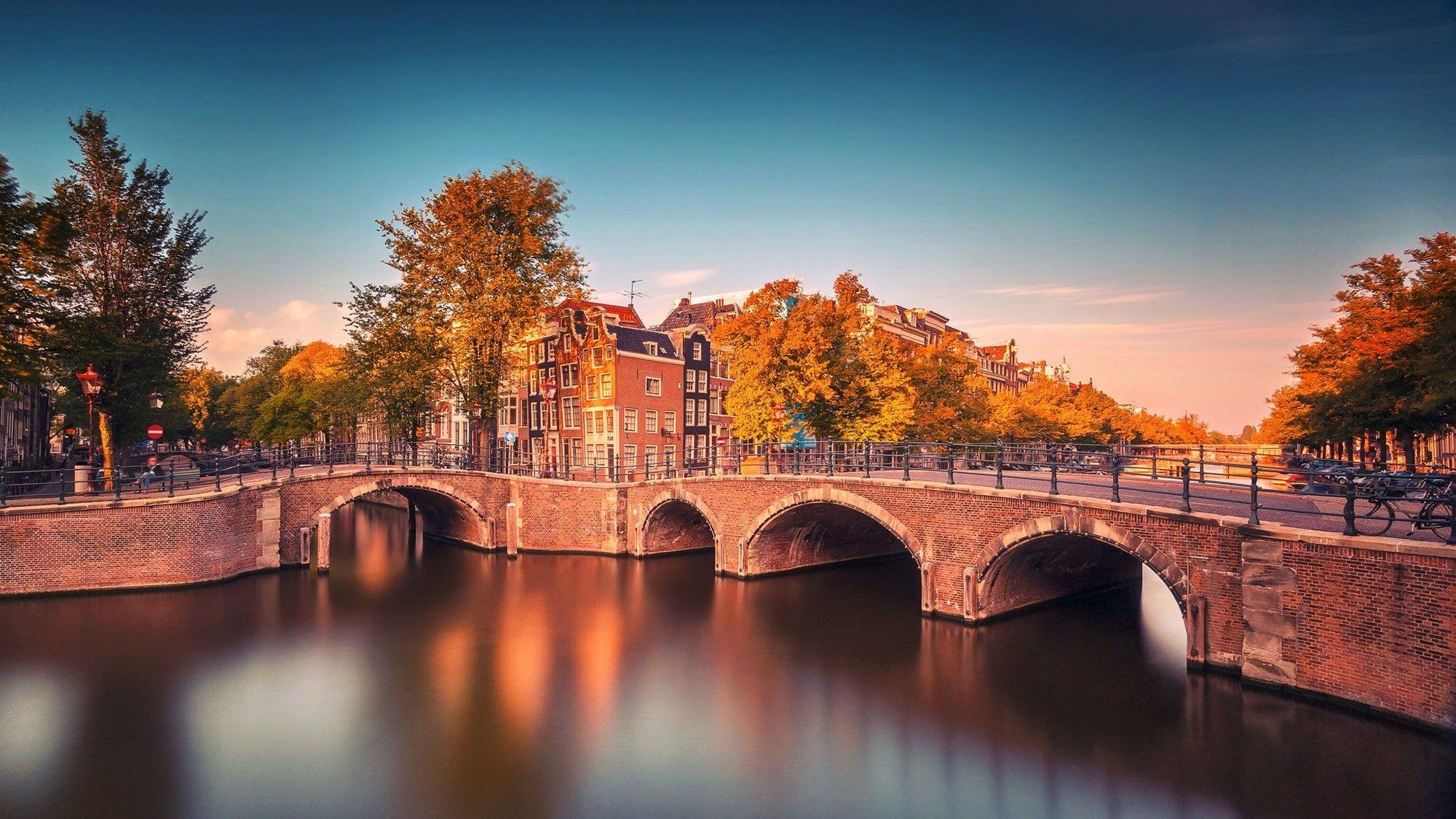 2000x1125 Amsterdam wallpaper, Nederland, bridge, fall, Buildings, trees, river, canal. Amsterdam wallpaper, North holland, Amsterdam photo