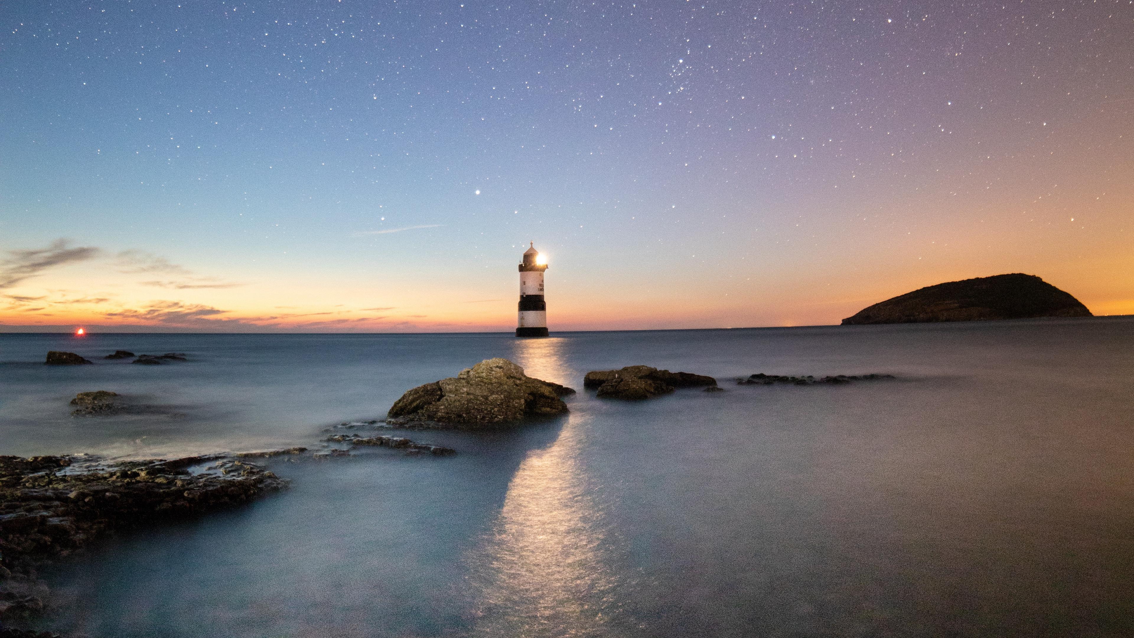 3840x2160 Wallpaper 4k lighthouse, starry sky, sea, penmon, united kingdom 4k Wallpaper