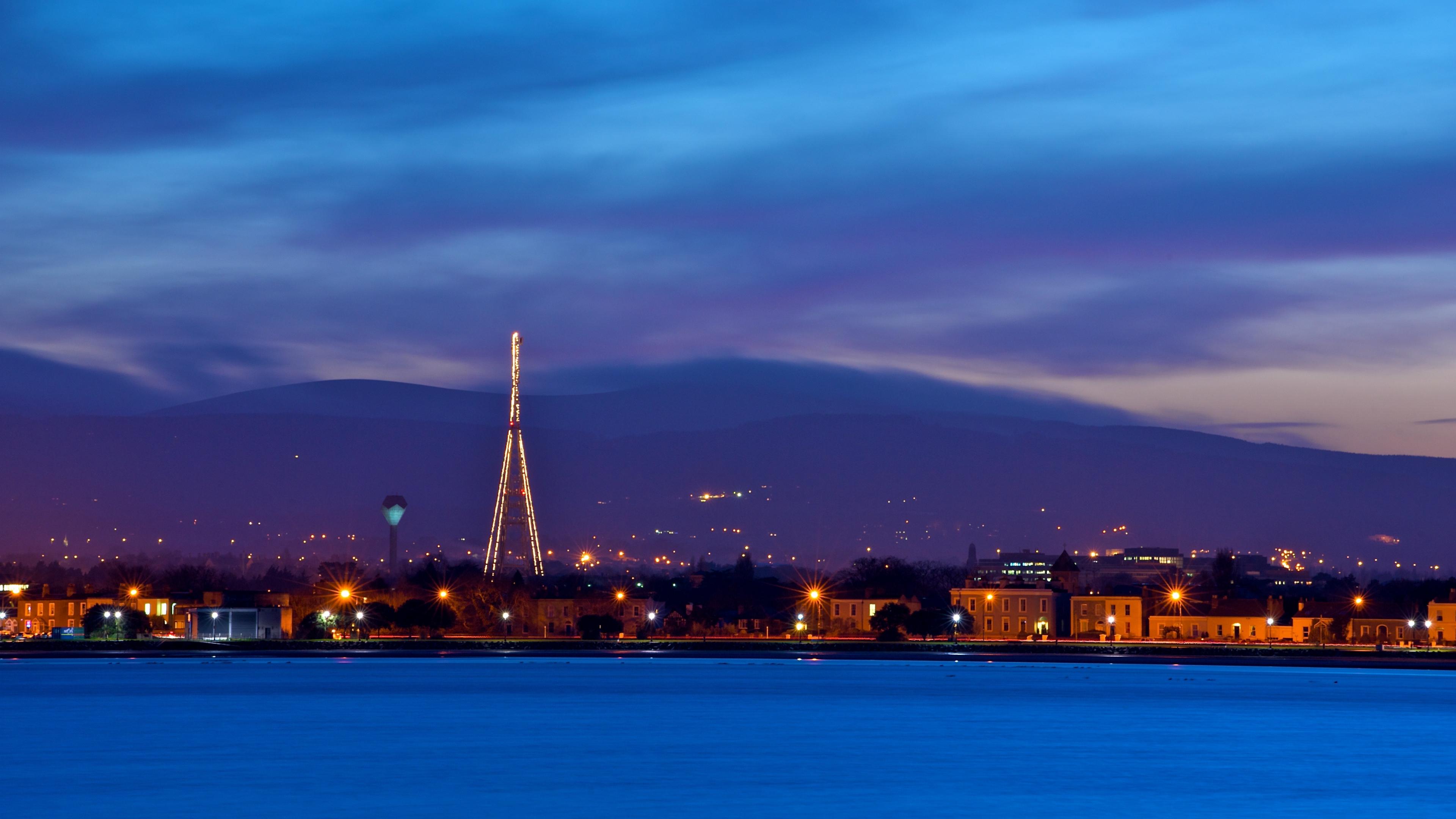 3840x2160 Wallpaper 4k ireland, dublin, evening, dusk, sky, blue, clouds, mountains, houses, lights, quay, river 4k Wallpaper