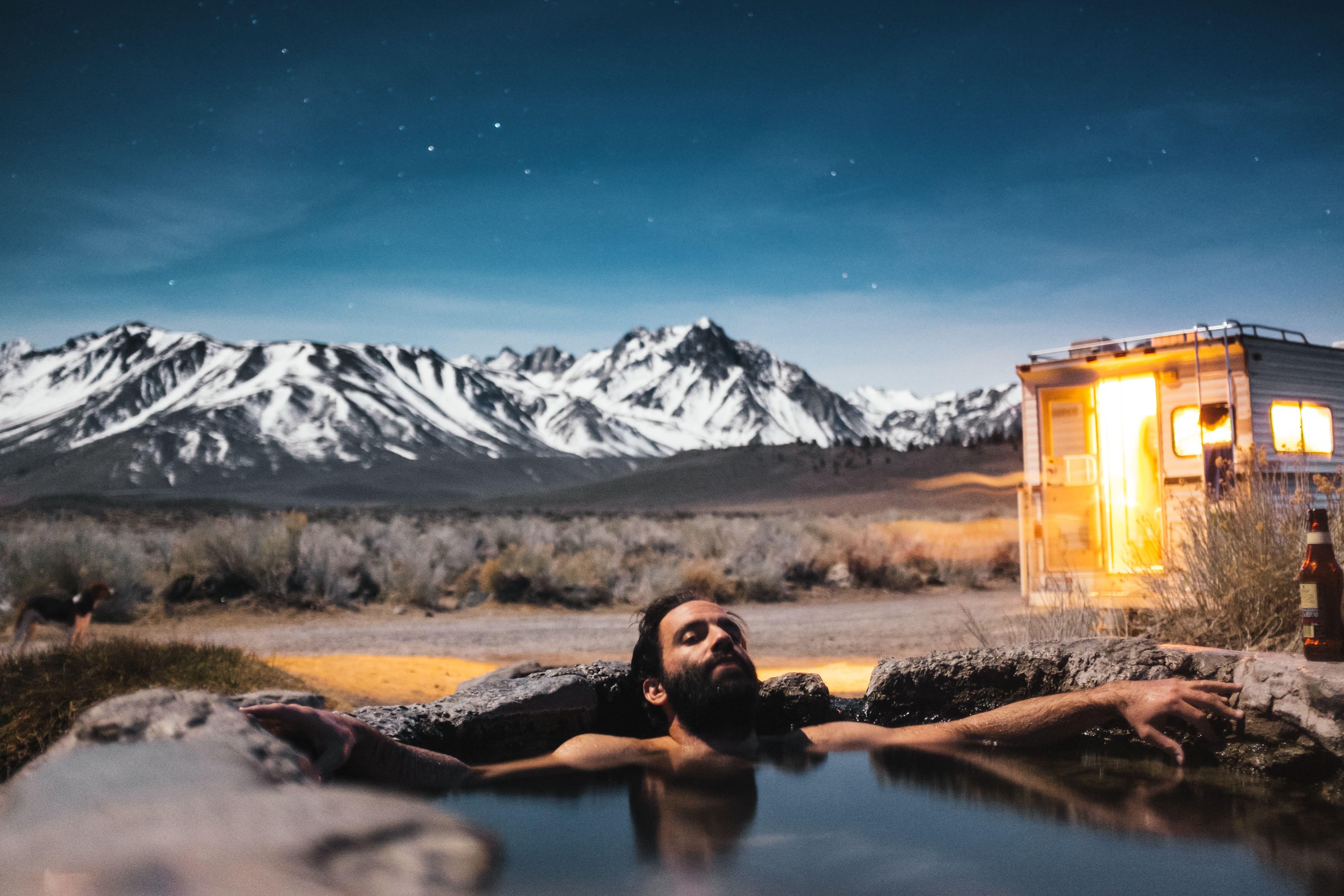 4896x3264 men in hot spring and ice covered mountains free image