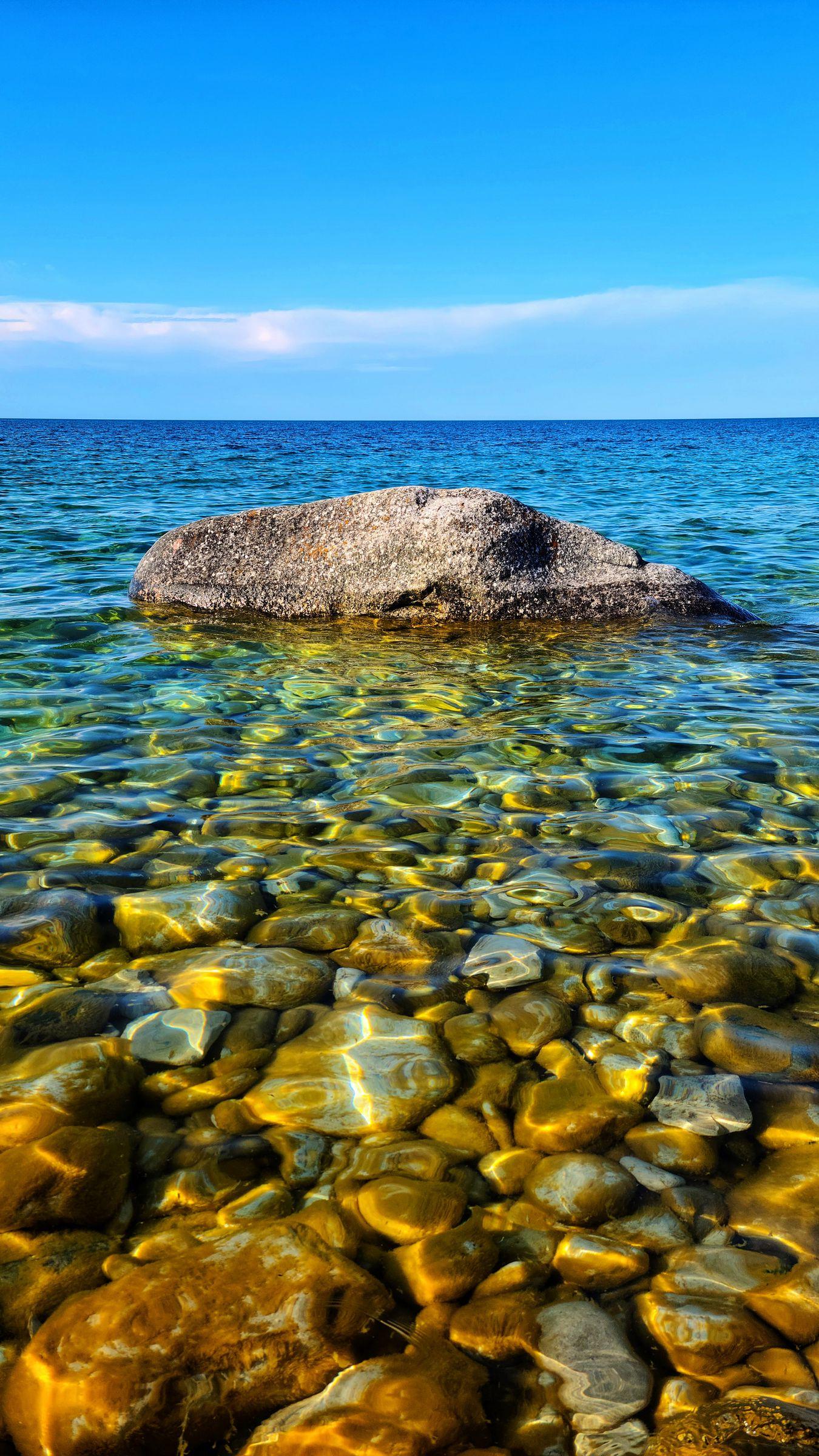 1350x2400 Download wallpaper 1350x2400 stone, water, pebbles, horizon iphone 8+/7+/6s+/for parallax HD background