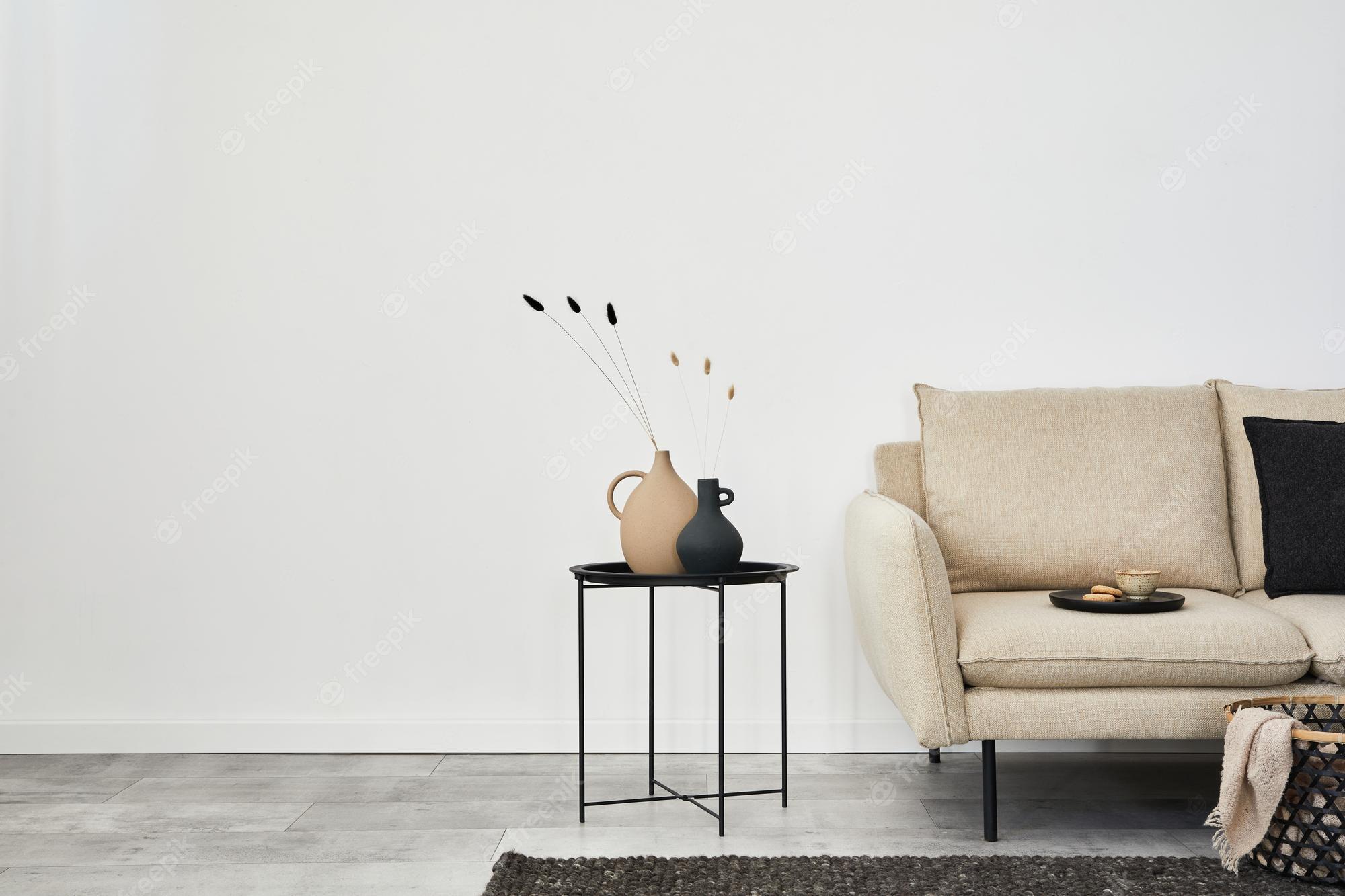 2000x1333 Premium Photo. Minimalist living room interior design with beige sofa creative metal side table and modern home accessories wallpaper copy space template