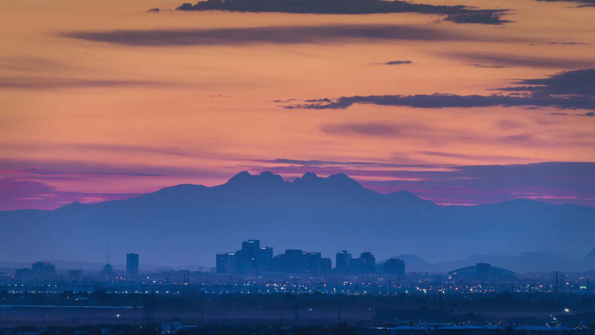 1920x1080 Download A City Skyline With Mountains In The Background Wallpaper