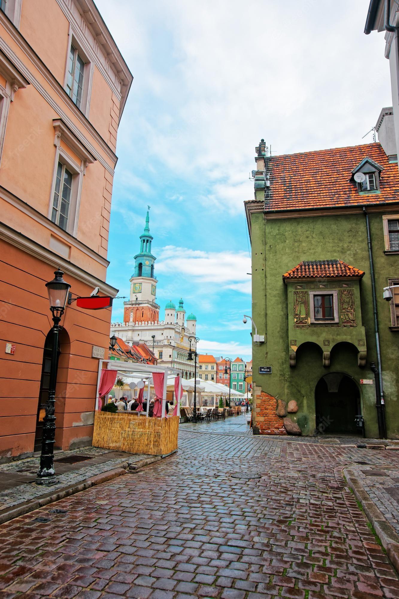 1333x2000 Premium Photo. Street view on old town hall on old market square in the city center of poznan, poland. people on the background