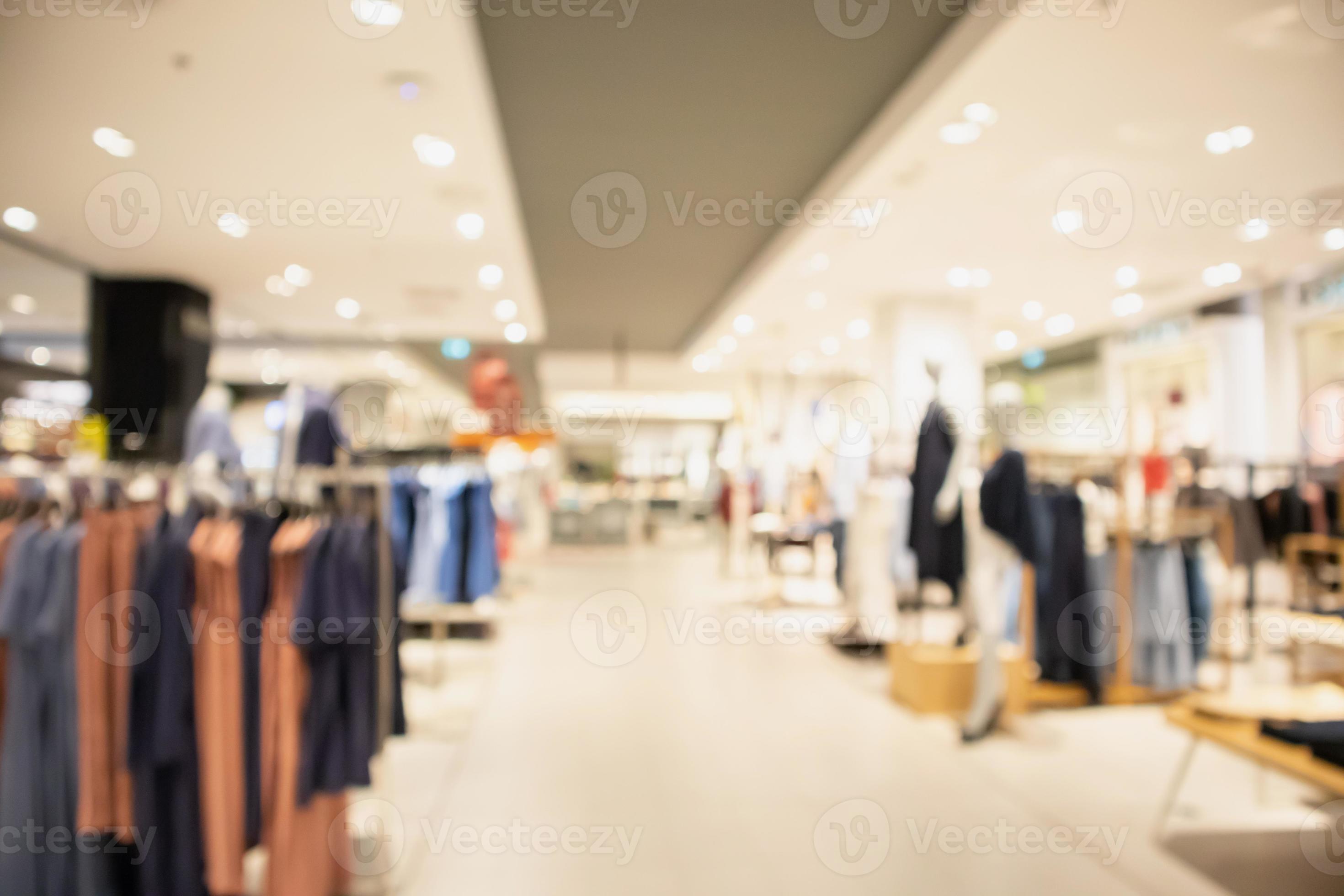 2940x1960 Woman fashionable boutique clothing store window display in shopping mall blur defocused background