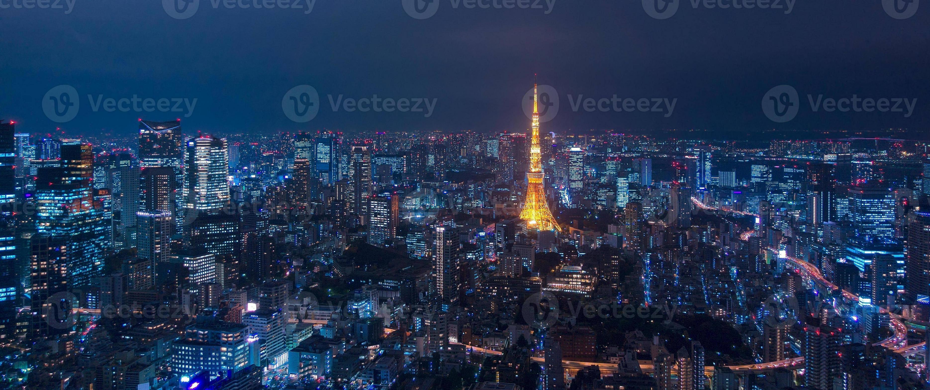 3740x1568 Aerial view over Tokyo tower and Tokyo cityscape view from Roppongi Hills at night in Tokyo at Japan