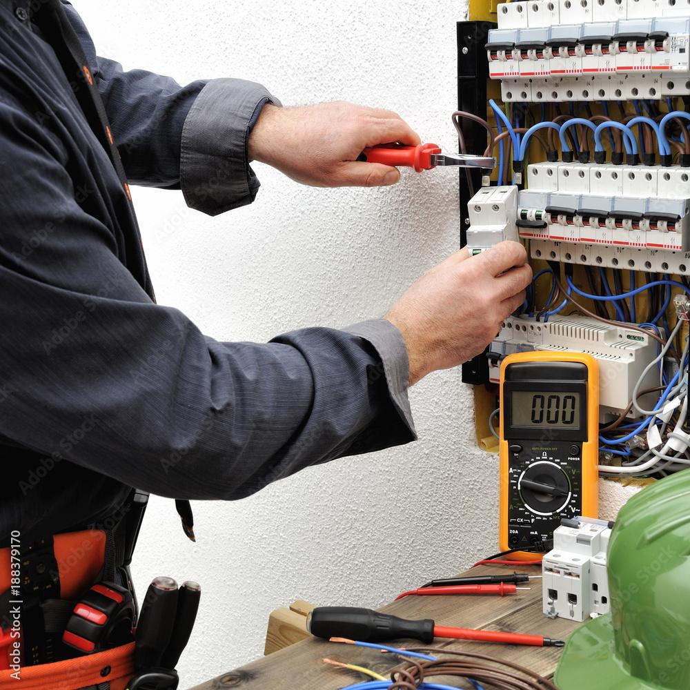 1000x1000 Elegant electrician technician at work on a residential electric panel