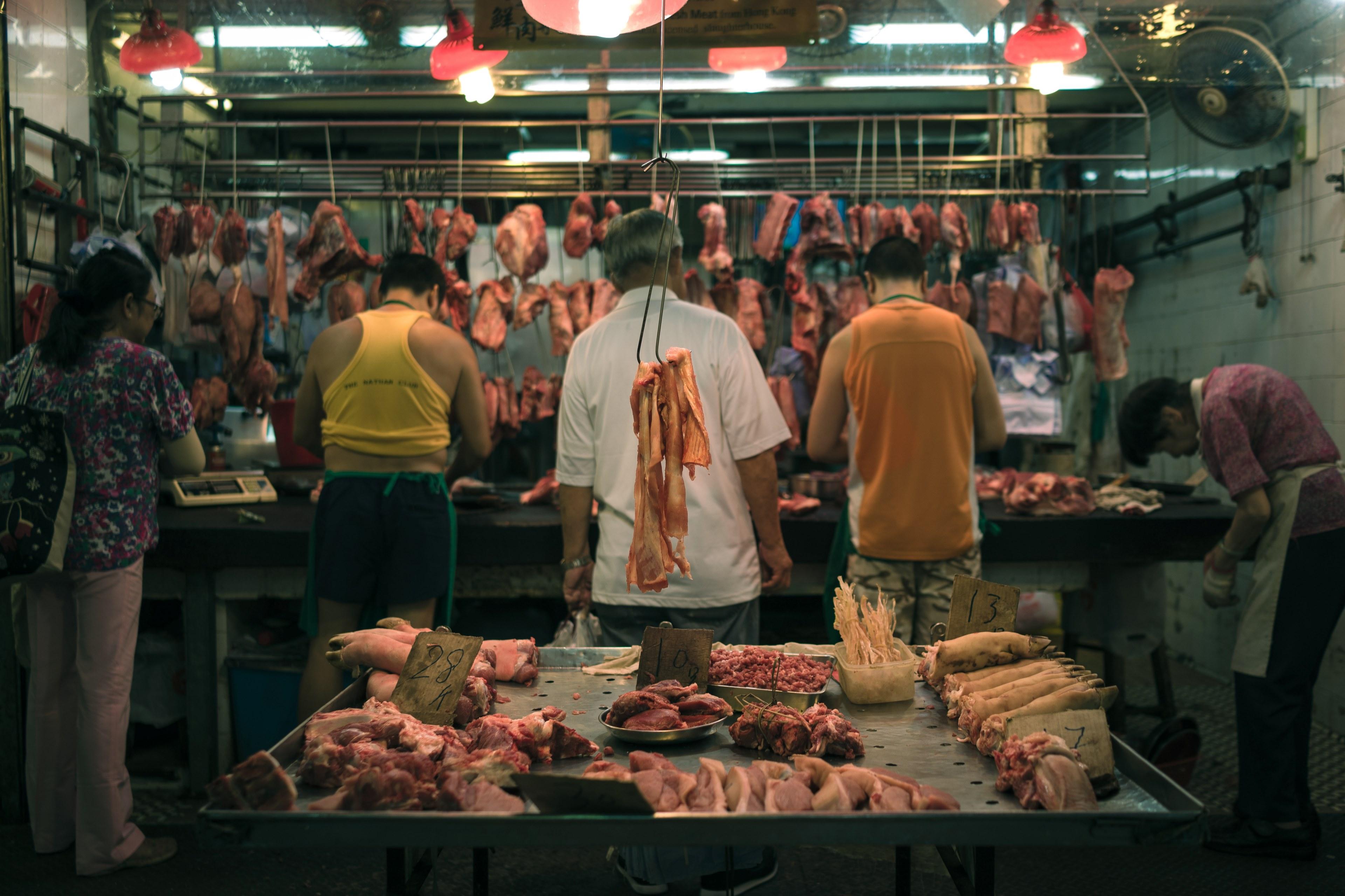 3840x2560 Wallpaper / people working at the butchers with pieces of meat suspended from a railing around them, butcher shop 4k wallpaper free download