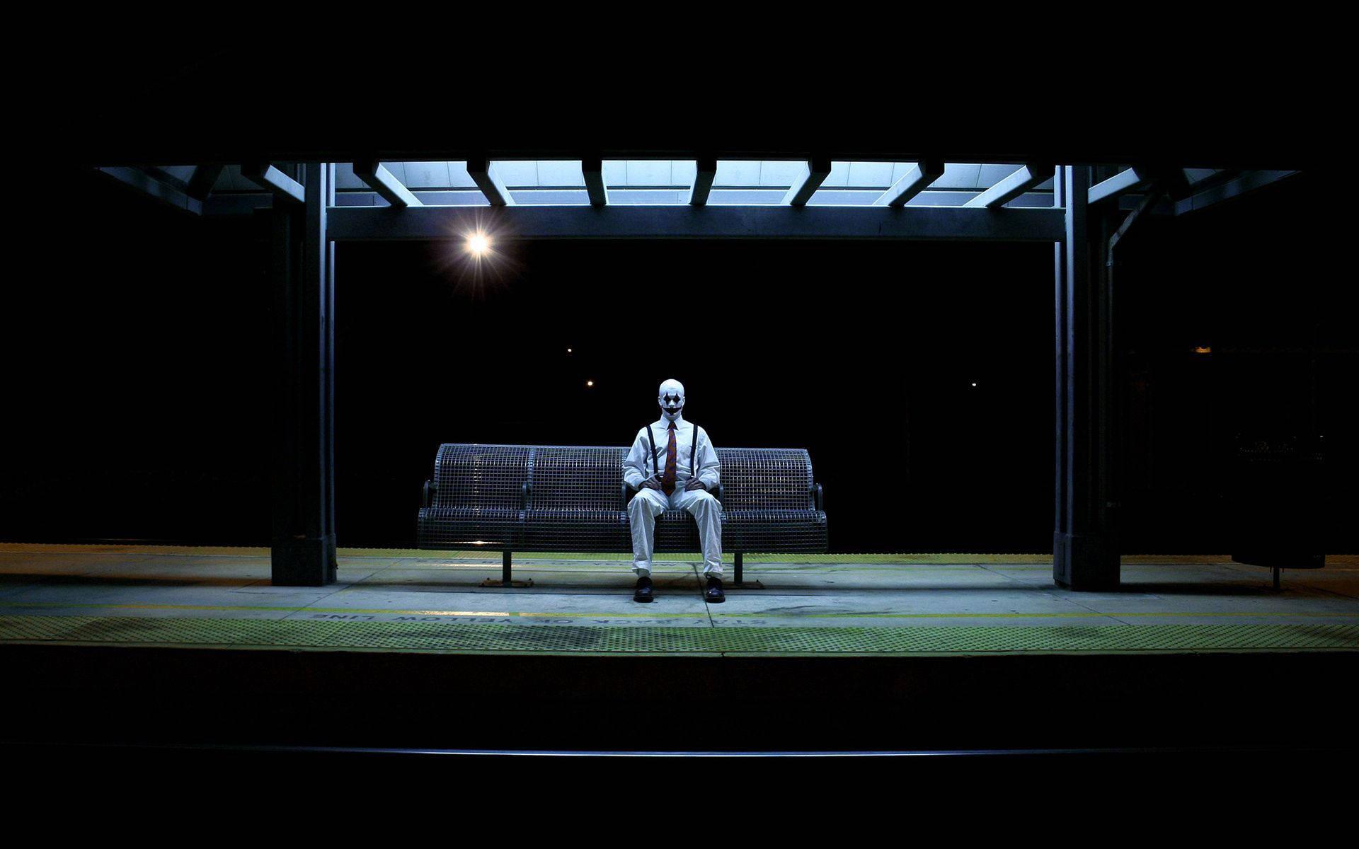 1920x1200 Download A clown waiting alone at a bus stop. Wallpaper
