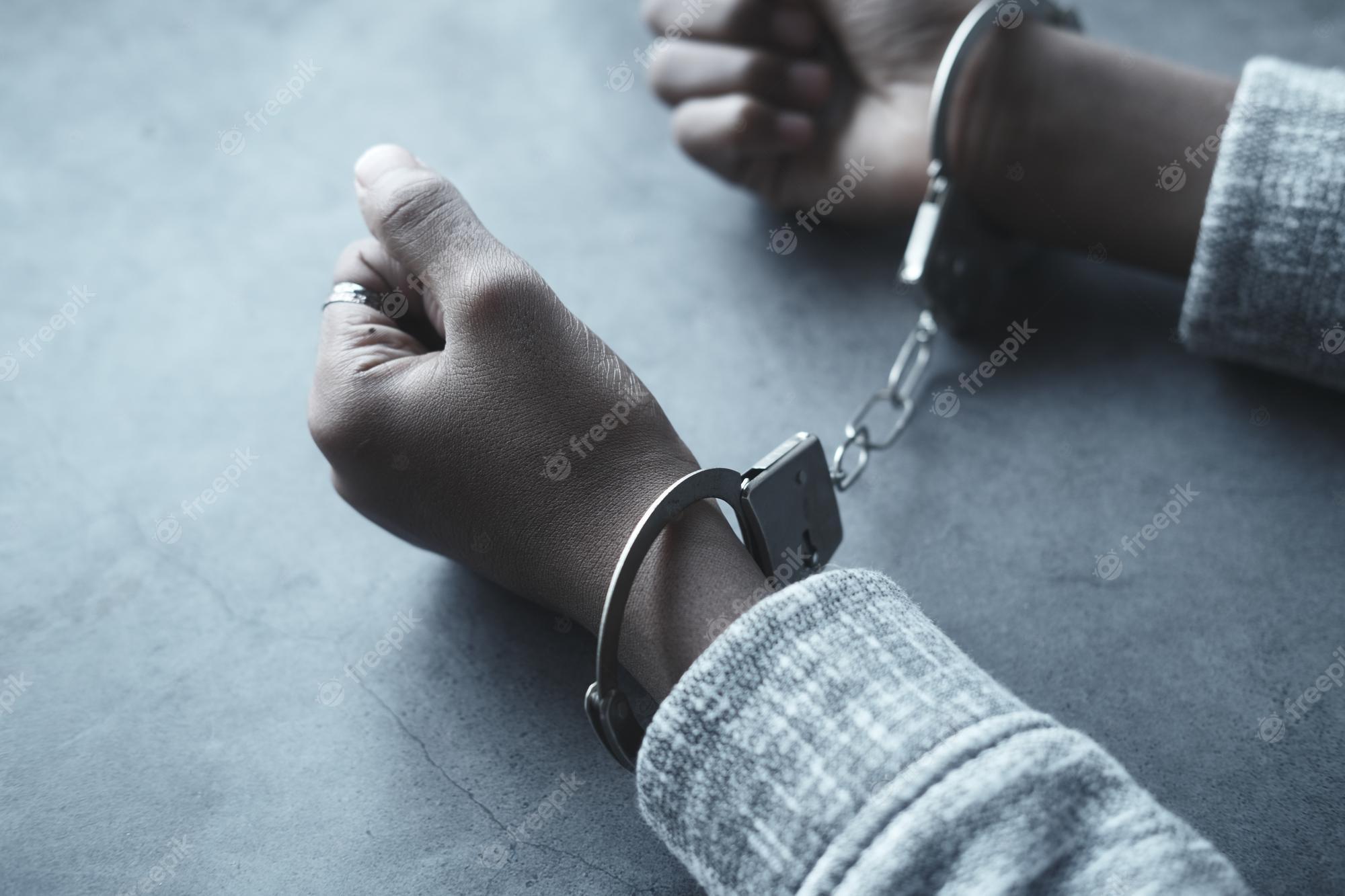 2000x1333 Premium Photo. Mans hand with handcuff on black background