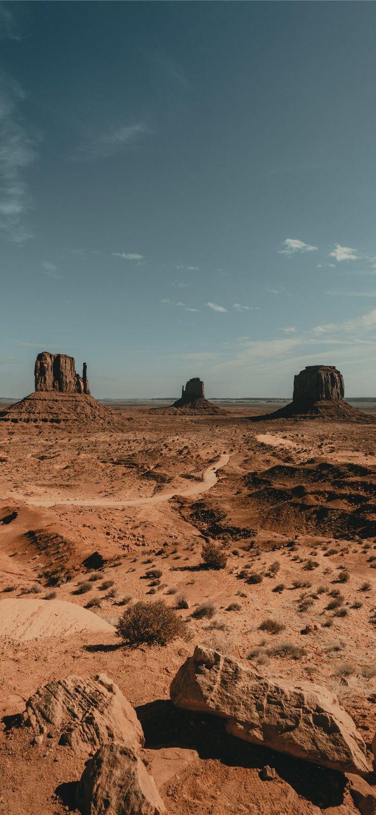736x1593 brown rock formation under white clouds