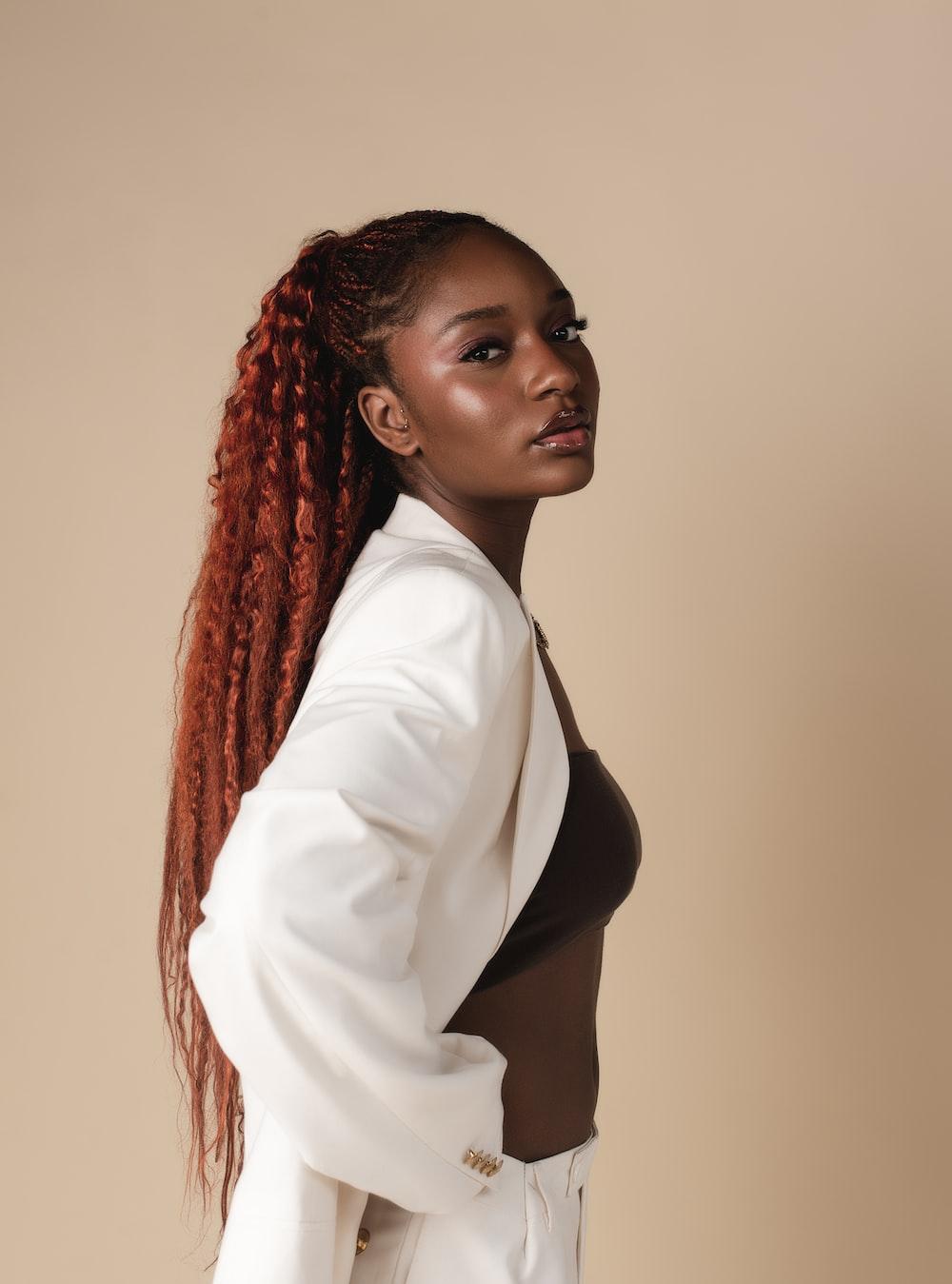 1000x1349 A woman with red hair wearing a white suit photo