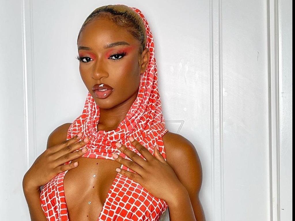 1024x768 Ayra Starr's Party Look Involves A Hooded Top and A Micro Mini Skirt
