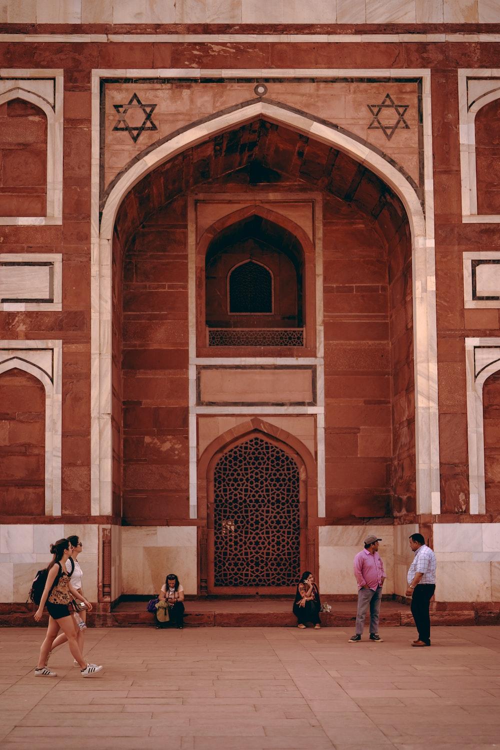 1000x1500 Men standing beside brown structure photo