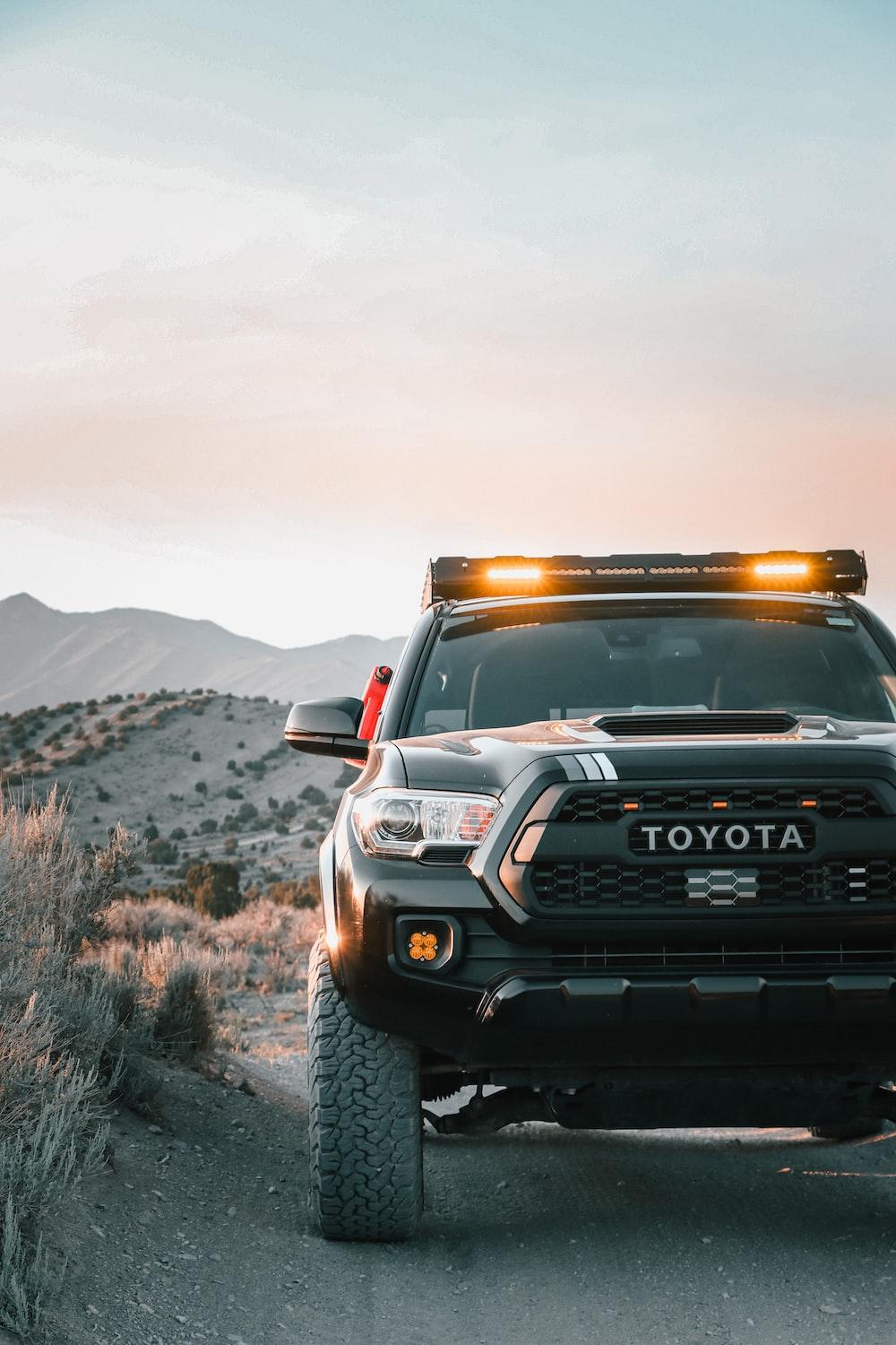 1000x1500 A toyota truck is parked on a dirt road photo
