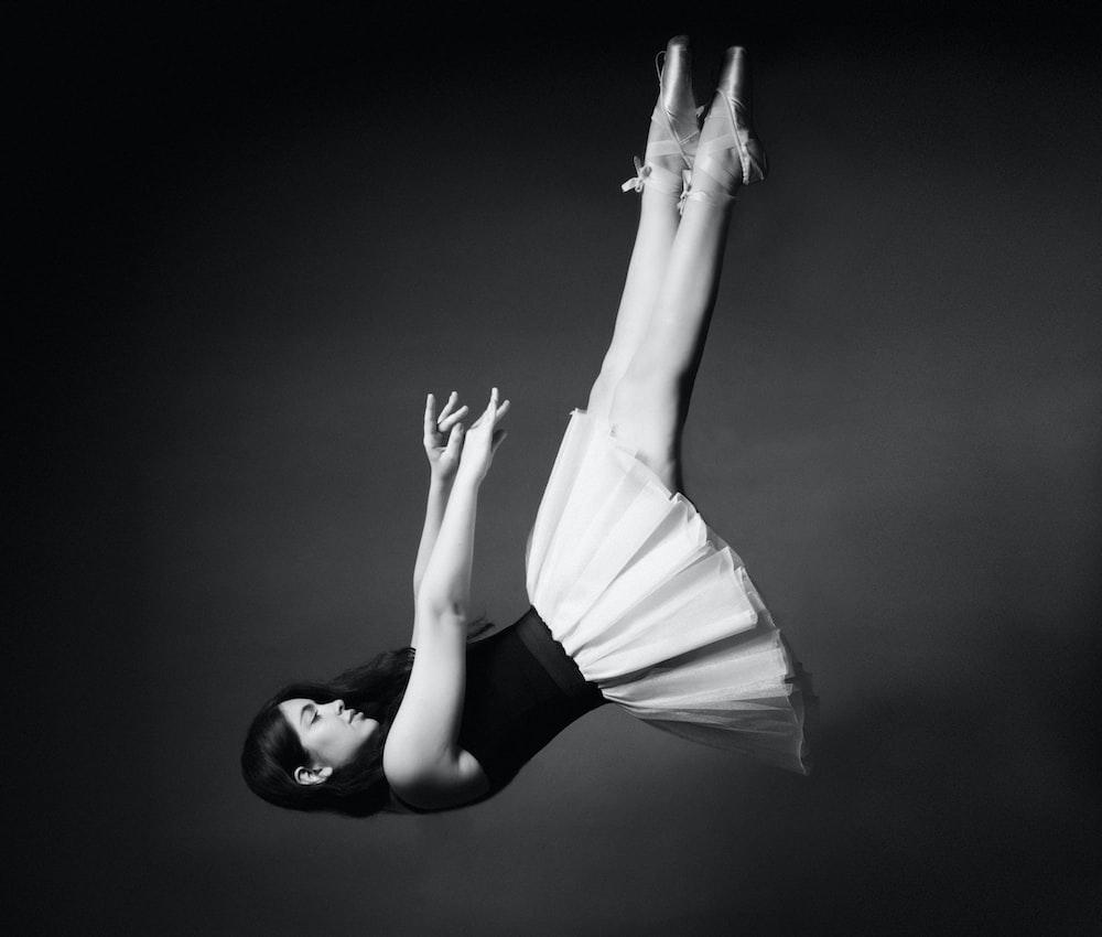 1000x850 A black and white photo of a woman doing a handstand photo
